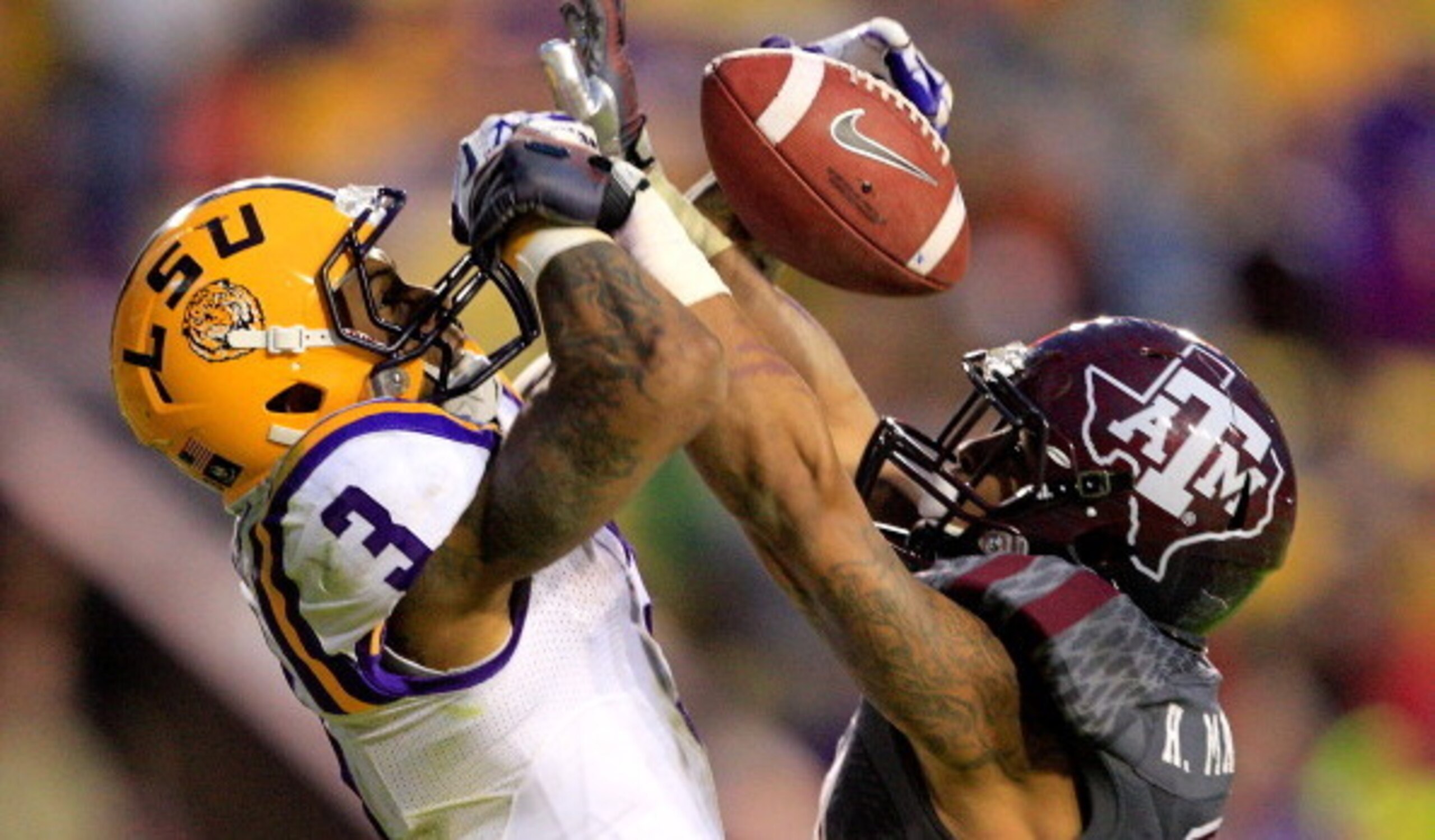 A&M safety Howard Matthews battles for the football