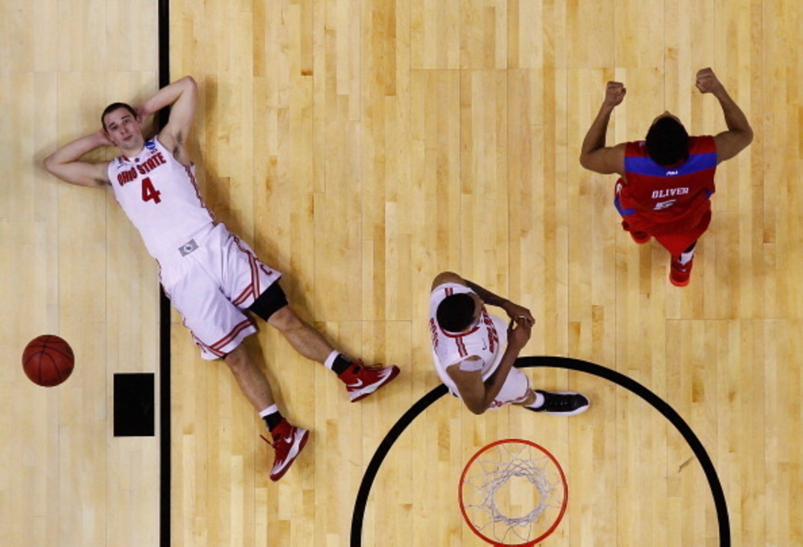 Ohio State's Aaron Craft lies dejected on the floor after his last-second shot rimmed out against Dayton.