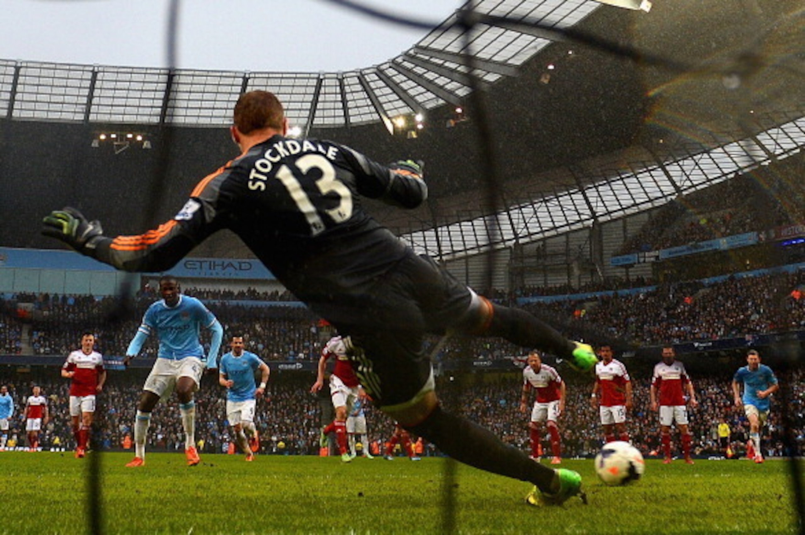 MANCHESTER, ENGLAND - MARCH 22: Yaya Toure of Manchester City scores his second goal from the penalty spot past David Stockdale of Fulham  during the Barclays Premier League match between Manchester City and Fulham at Etihad Stadium on March 22, 2014 in M