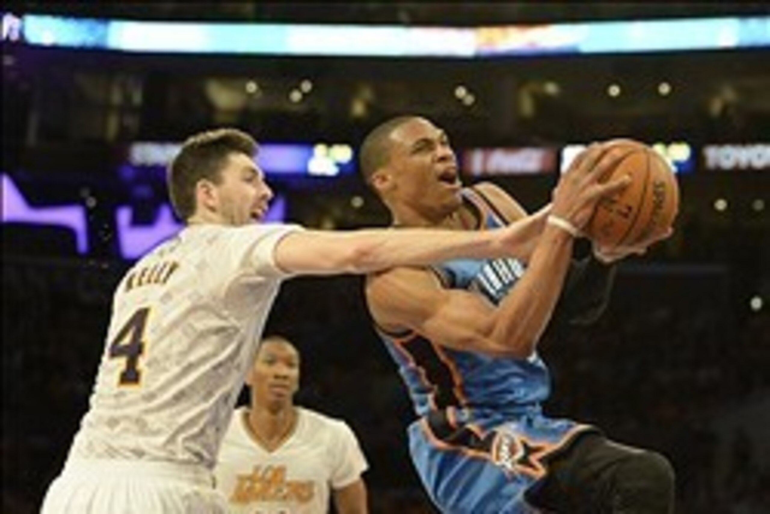 Mar 9, 2014; Los Angeles, CA, USA; Los Angeles Lakers power forward Ryan Kelly (4) defends against Oklahoma City Thunder point guard Russell Westbrook (0) during the first half at Staples Center. Mandatory Credit: Richard Mackson-USA TODAY Sports