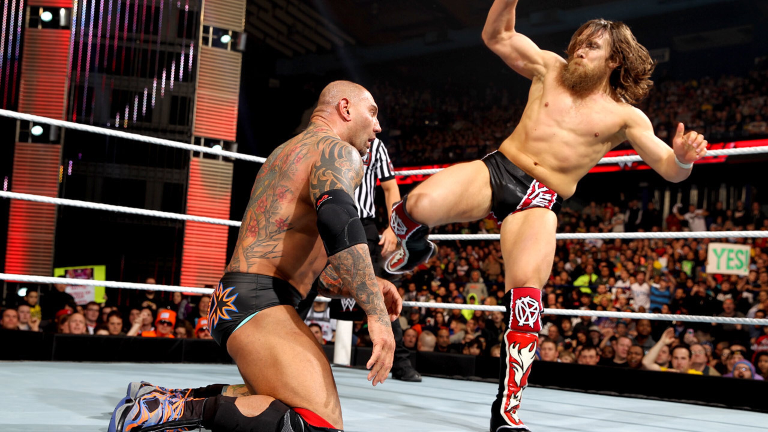 Daniel Bryan aims a kick at Batista.