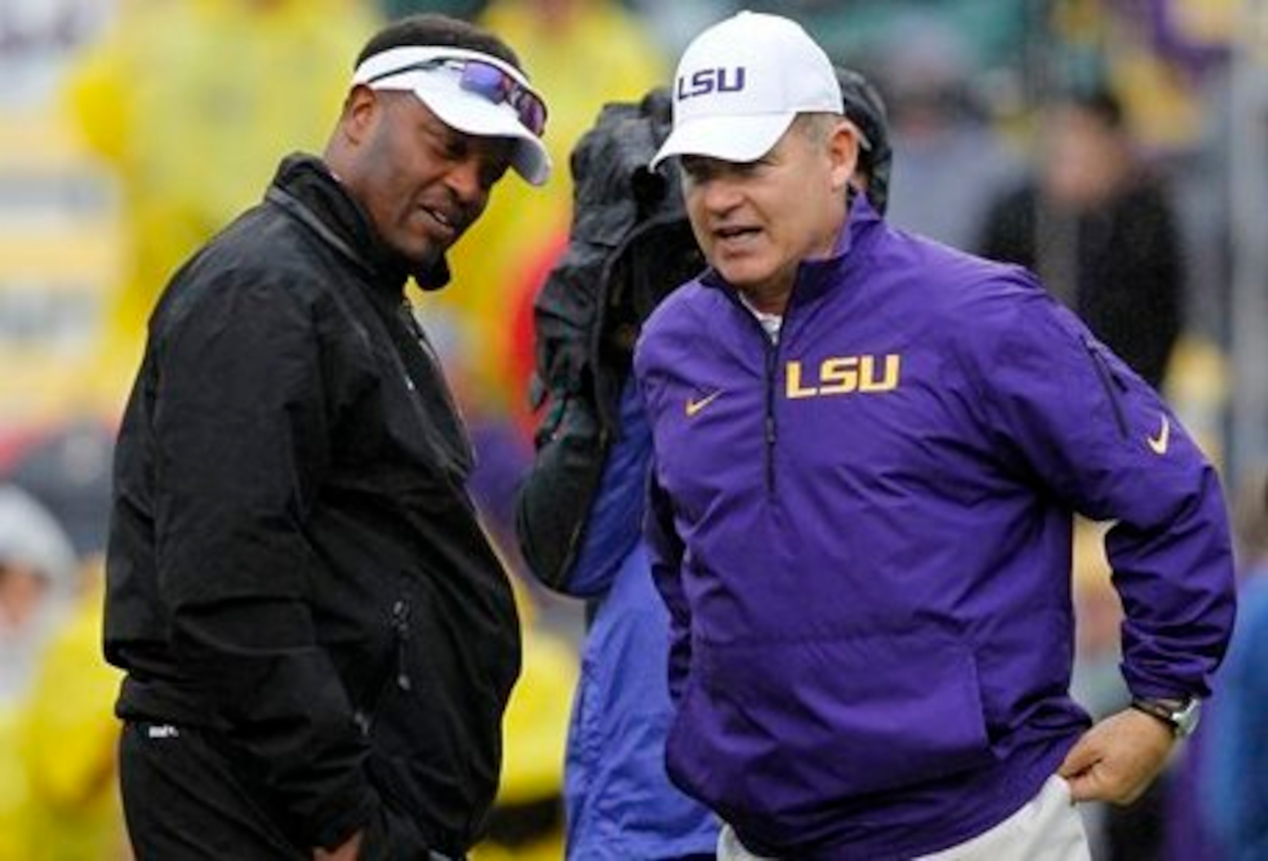 Texas A&M head coach Kevin Sumlin (left) and LSU head coach Les Miles