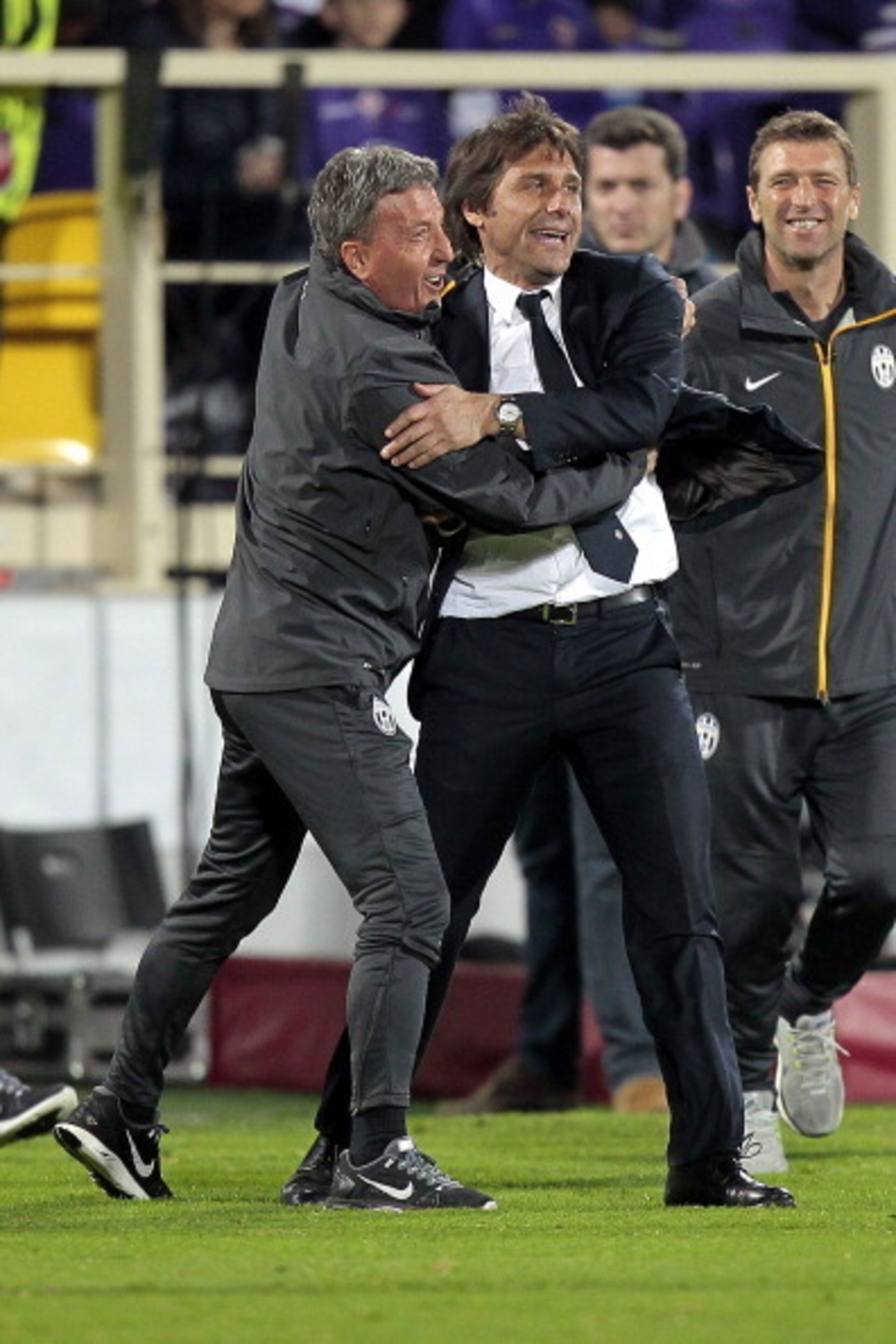 Antonio Conte celebrates Andrea Pirlo's decider against Fiorentina with his staff.