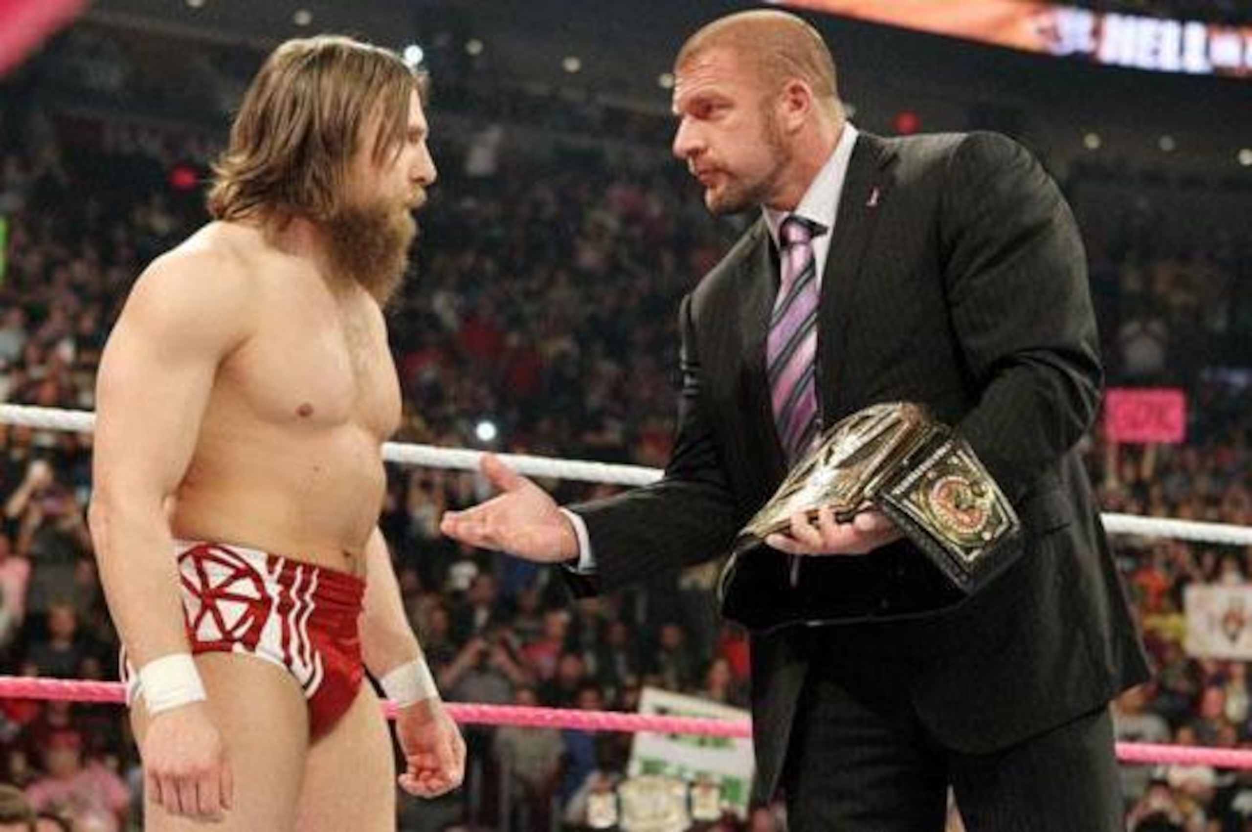 Triple H strips Daniel Bryan of his WWE Championship.