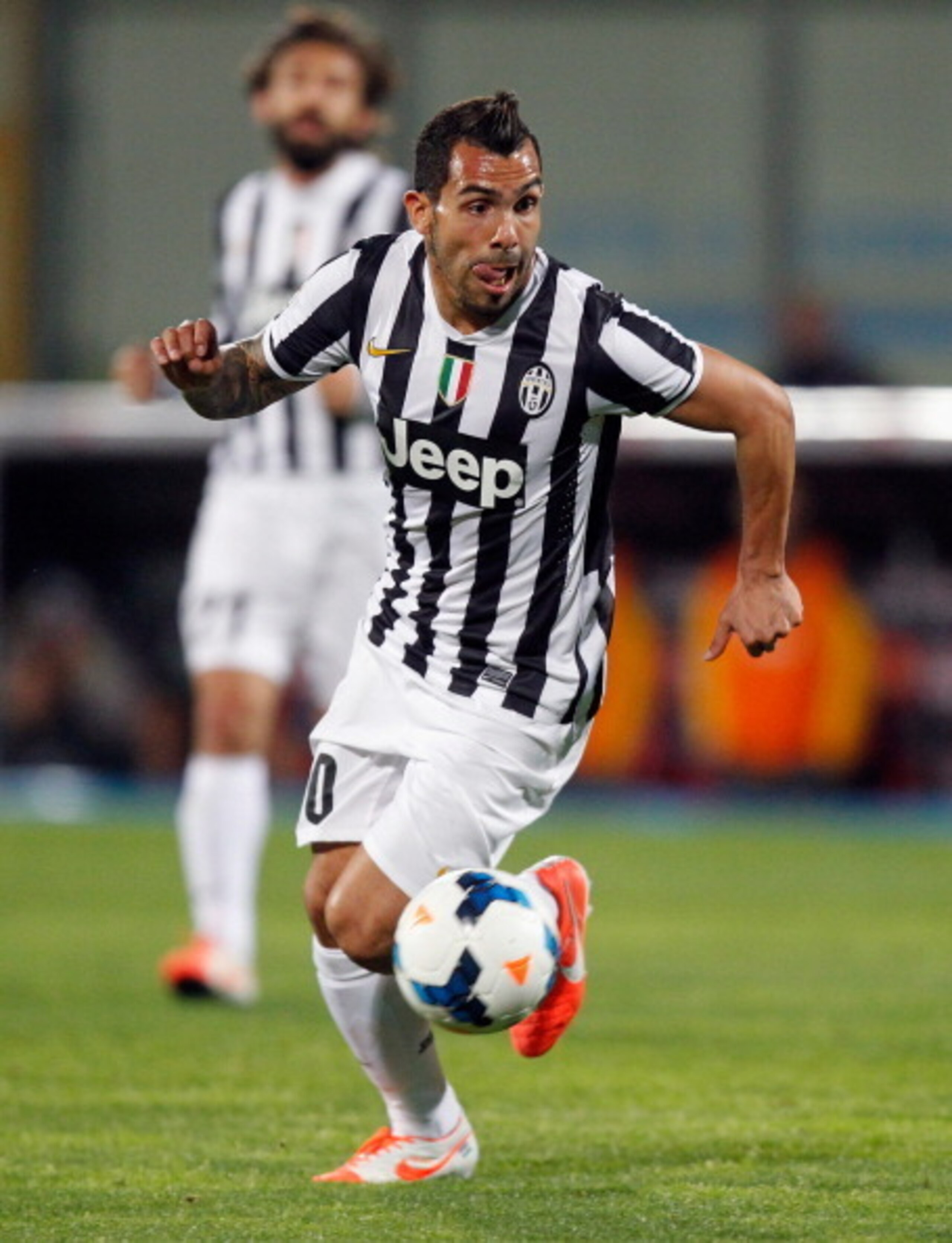 Carlos Tevez sizes up his options in Serie A action against Catania.