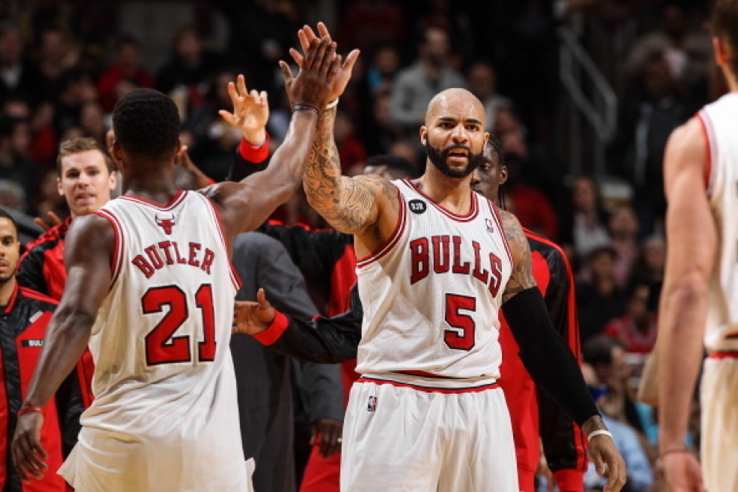 Chicago Bulls forwards Jimmy Butler and Carlos Boozer exchange salutations.