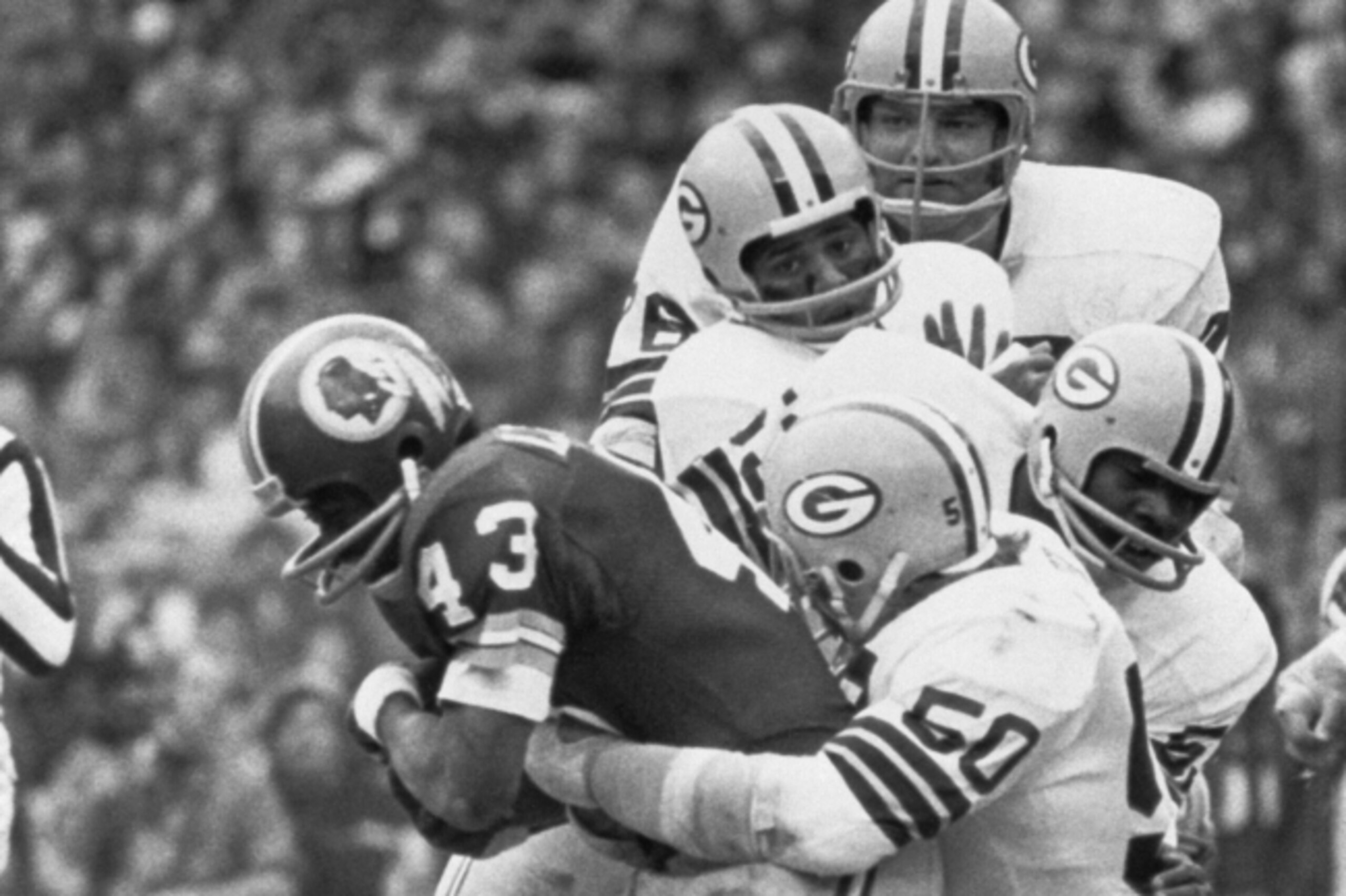 Jim Carter wraps up Larry Brown of the Redskins in 1972.