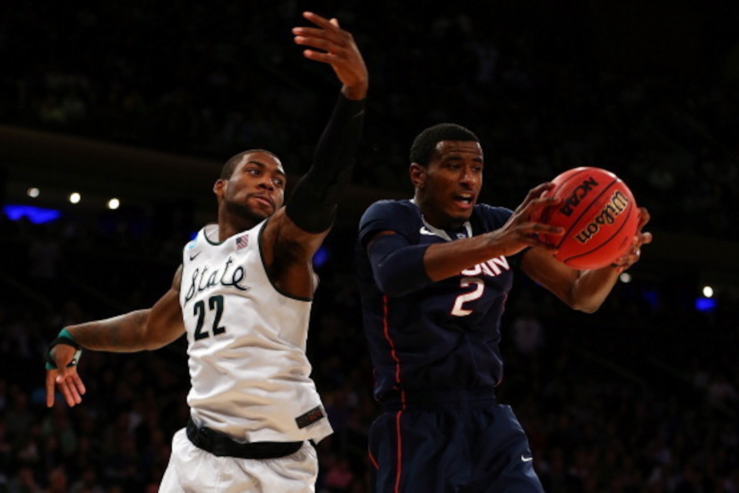 NEW YORK, NY - MARCH 30:  DeAndre Daniels #2 of the Connecticut Huskies grabs a rebound against Branden Dawson #22 of the Michigan State Spartans during the East Regional Final of the 2014 NCAA Men's Basketball Tournament at Madison Square Garden on March