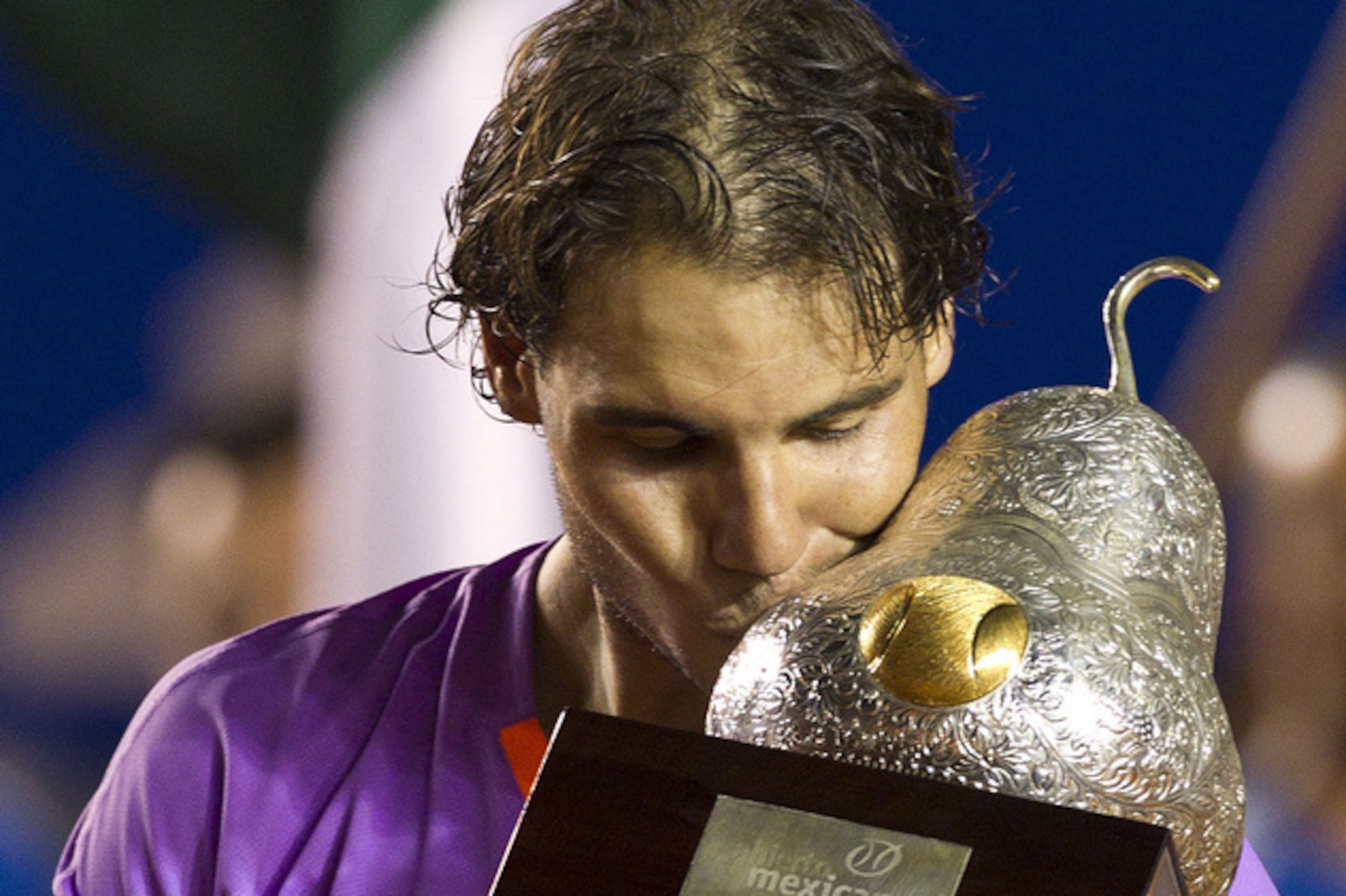Rafael Nadal bites down on a golden pear trophy at the 2013 Acapulco Open. Rafael Nadal bites down on a golden pear trophy at the 2013 Acapulco Open.