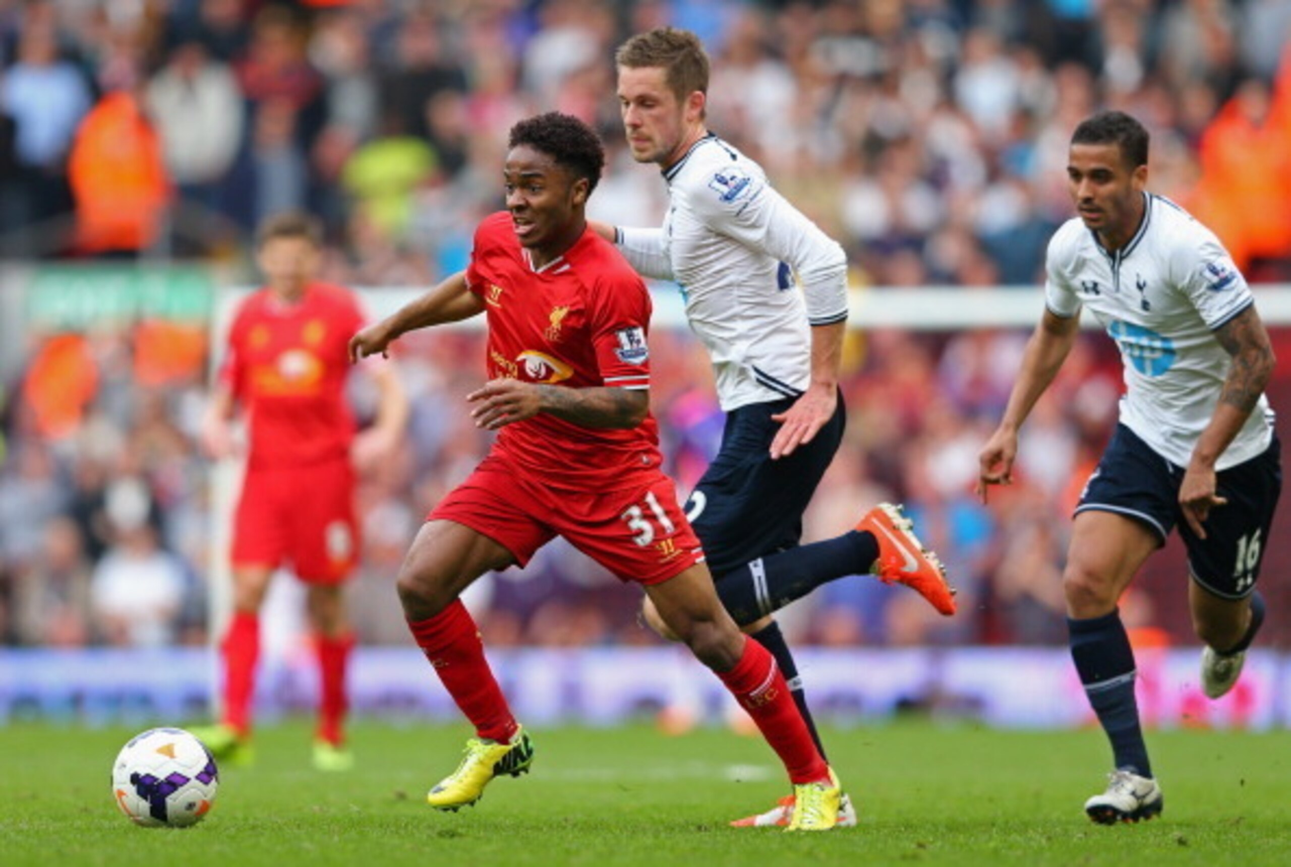 Spurs' midfielder Gylfi Sigurdsson chases Liverpool's Raheem Sterling in the 4-0 loss at Anfield.
