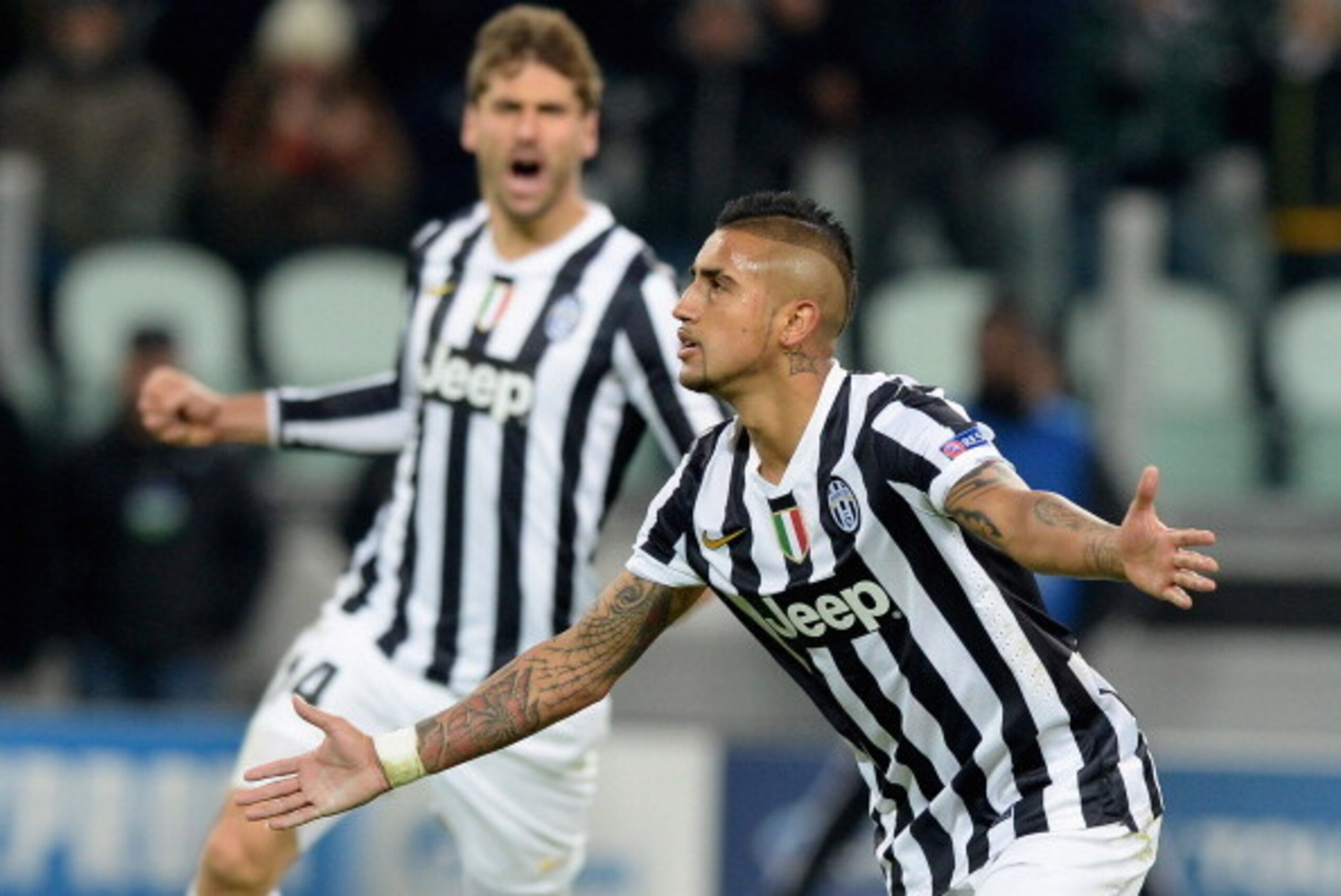 Arturo Vidal—with Fernando Llorente in the background—celebrates one of three goals against Copenhagen in the Champions League.