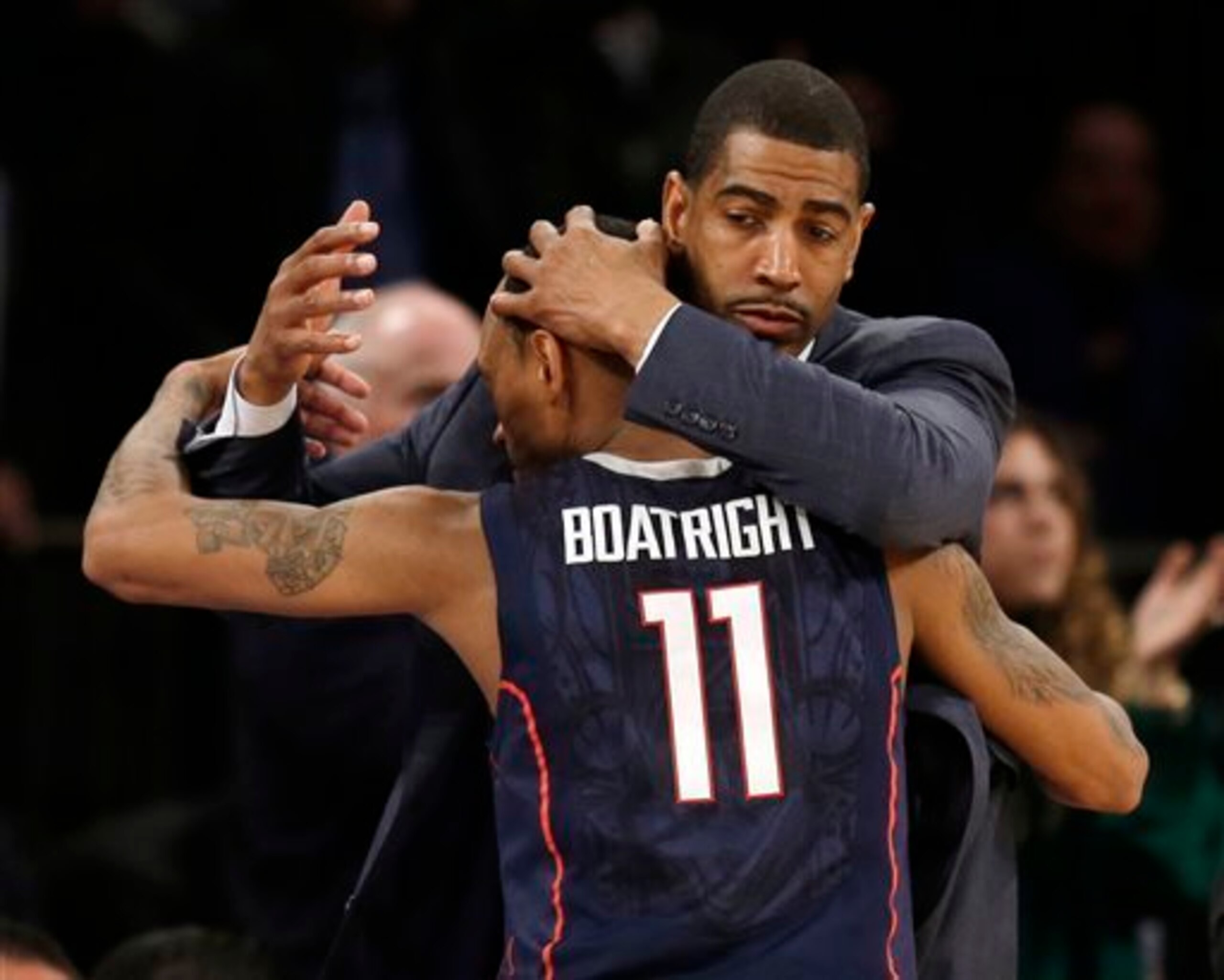 Connecticut coach Kevin Ollie gives junior guard Ryan Boatright a well-deserved hug after another upset.