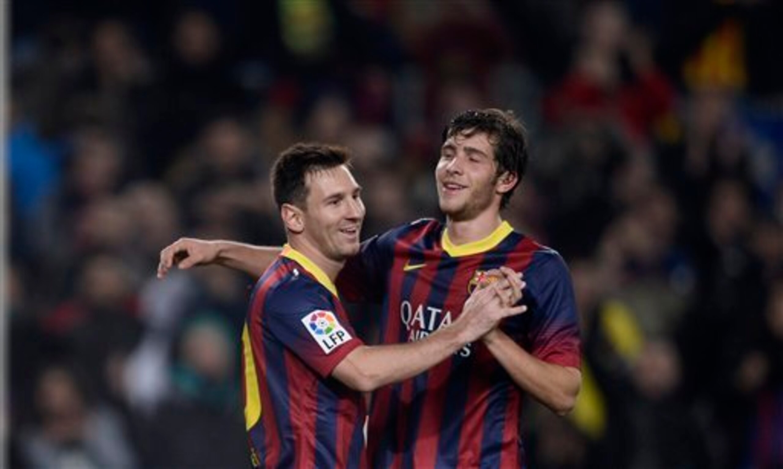 Promising midfielder Sergi Roberto celebrates with Lionel Messi in this season's Copa Del Rey.