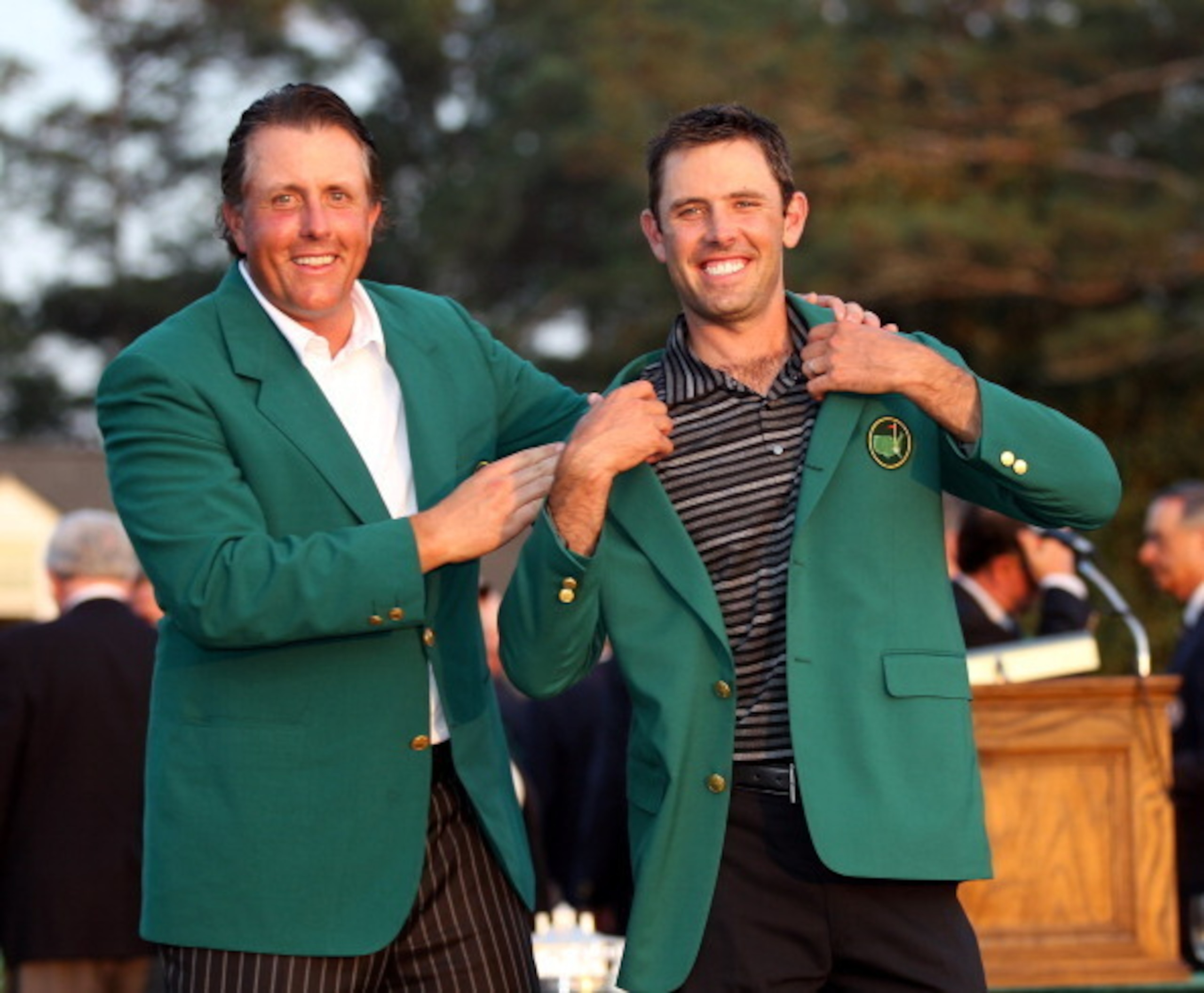 Charl Schwartzel accepts the green jacket from 2010 Masters champion Phil Mickelson.