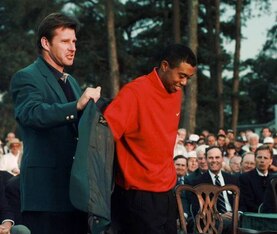 Tiger Woods accepts his first green jacket from Nick Faldo.