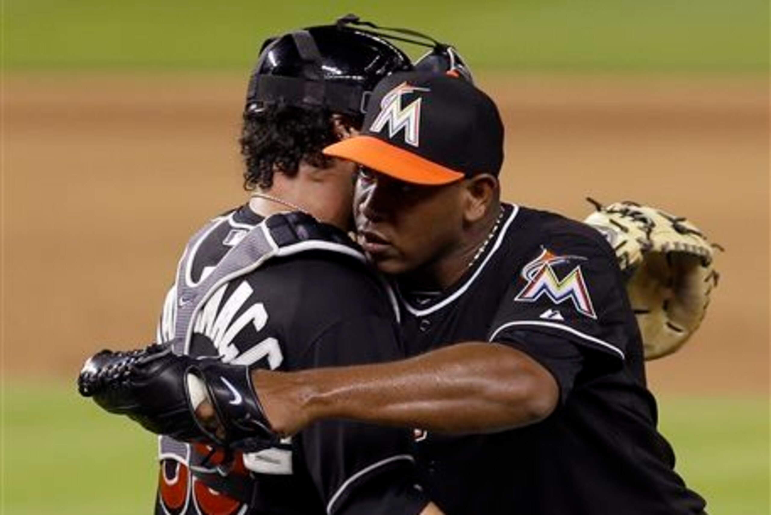 Jarrod Saltalamacchia, left, and Carlos Marmol share a hug. Does that mean they got a good grade as one of the Miami Marlins' offseason acquisitions?