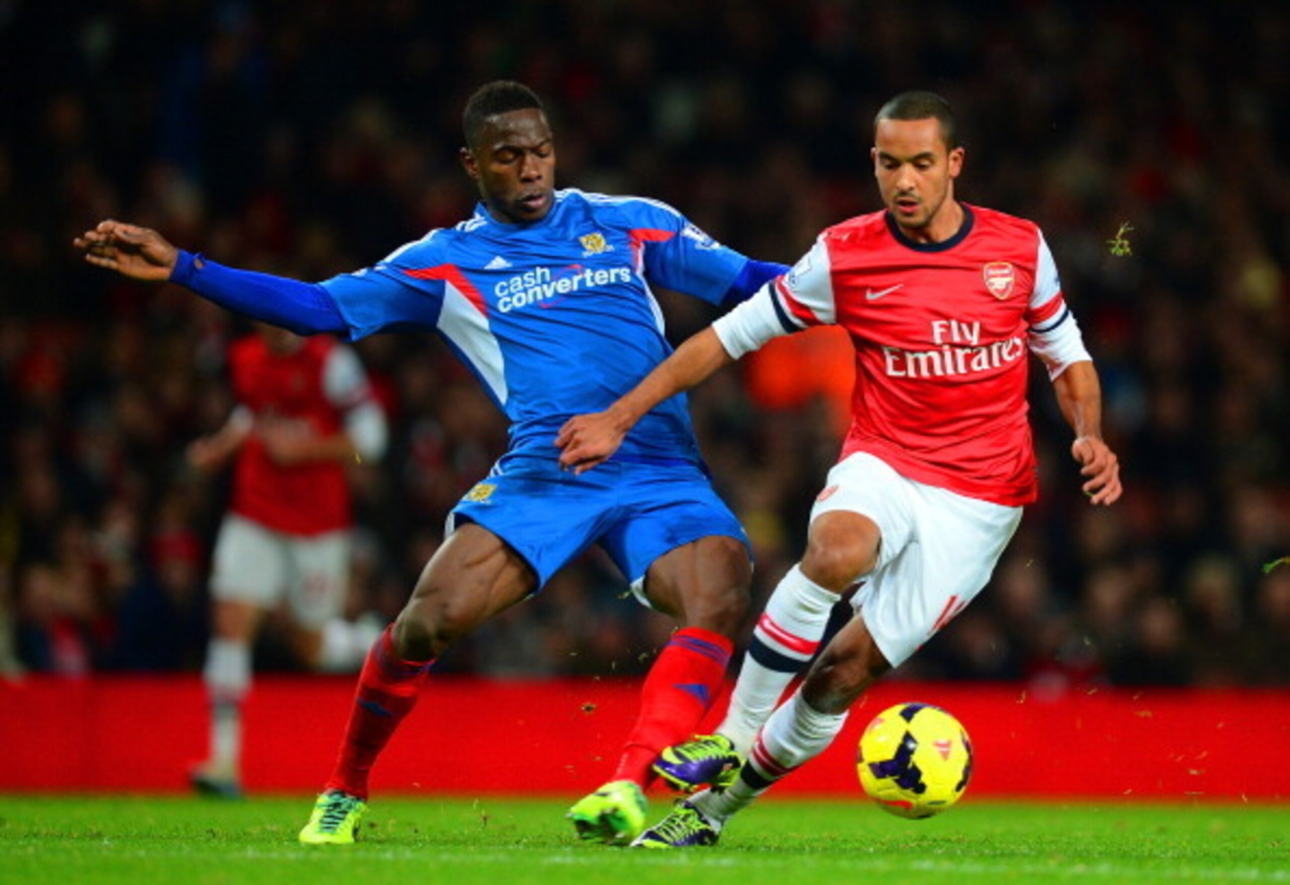 Hull City defender Maynor Figueroa battles Arsenal's Theo Walcott for the ball. Hull City defender Maynor Figueroa battles Arsenal's Theo Walcott for the ball.