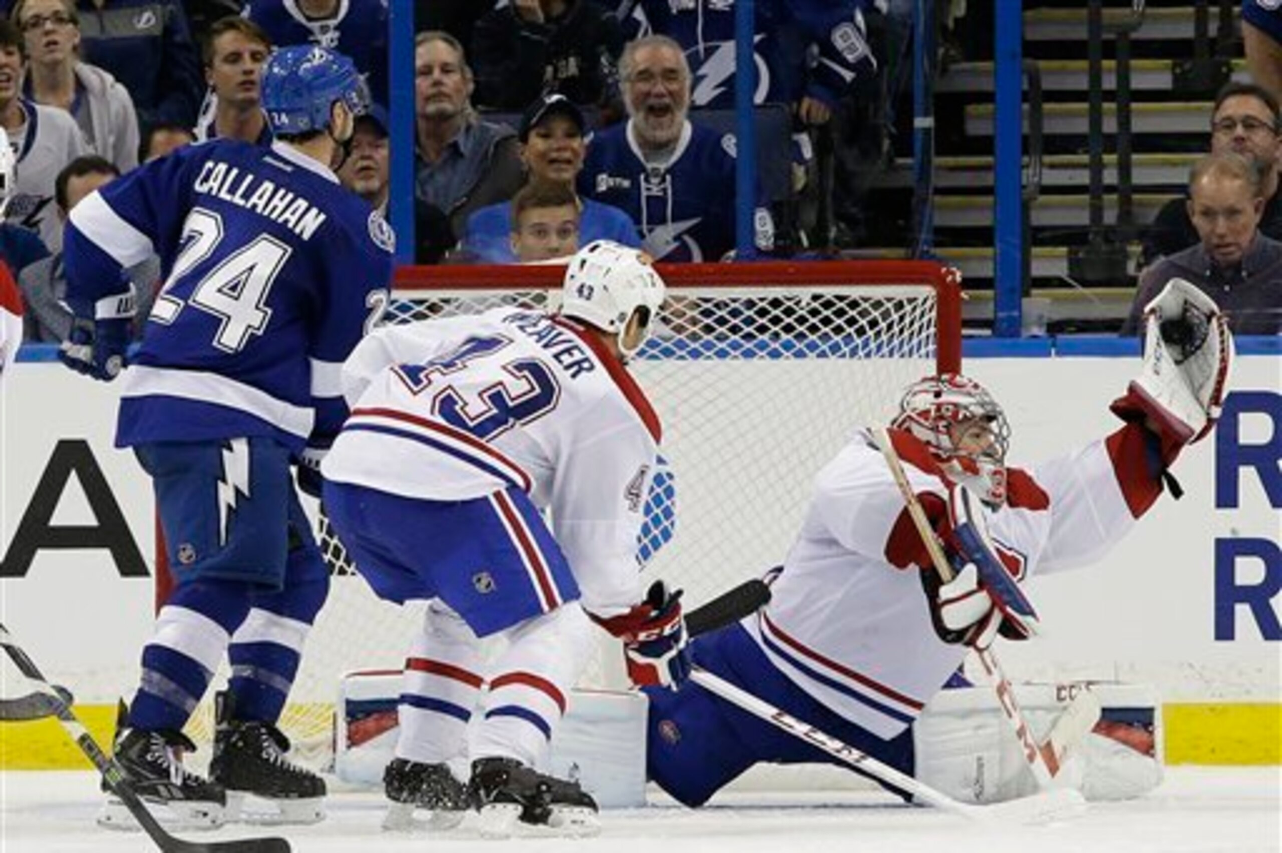 Montreal Canadiens goaltender Carey Price makes a save in front of defenseman Mike Weaver and Tampa Bay Lightning forward Ryan Callahan.