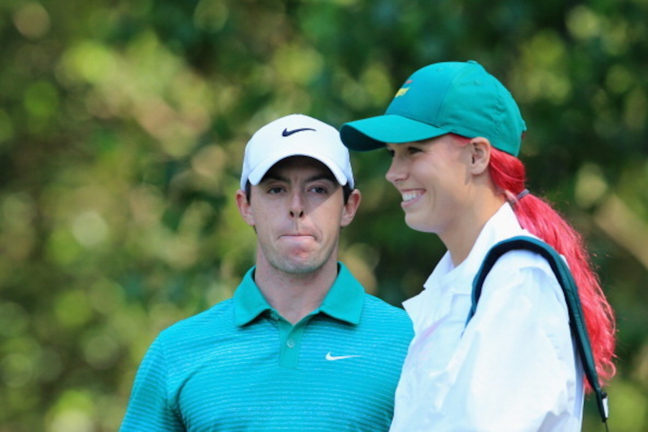 Caroline Wozniacki plays caddy for boyfriend Rory McIlroy at the Masters golf tournament