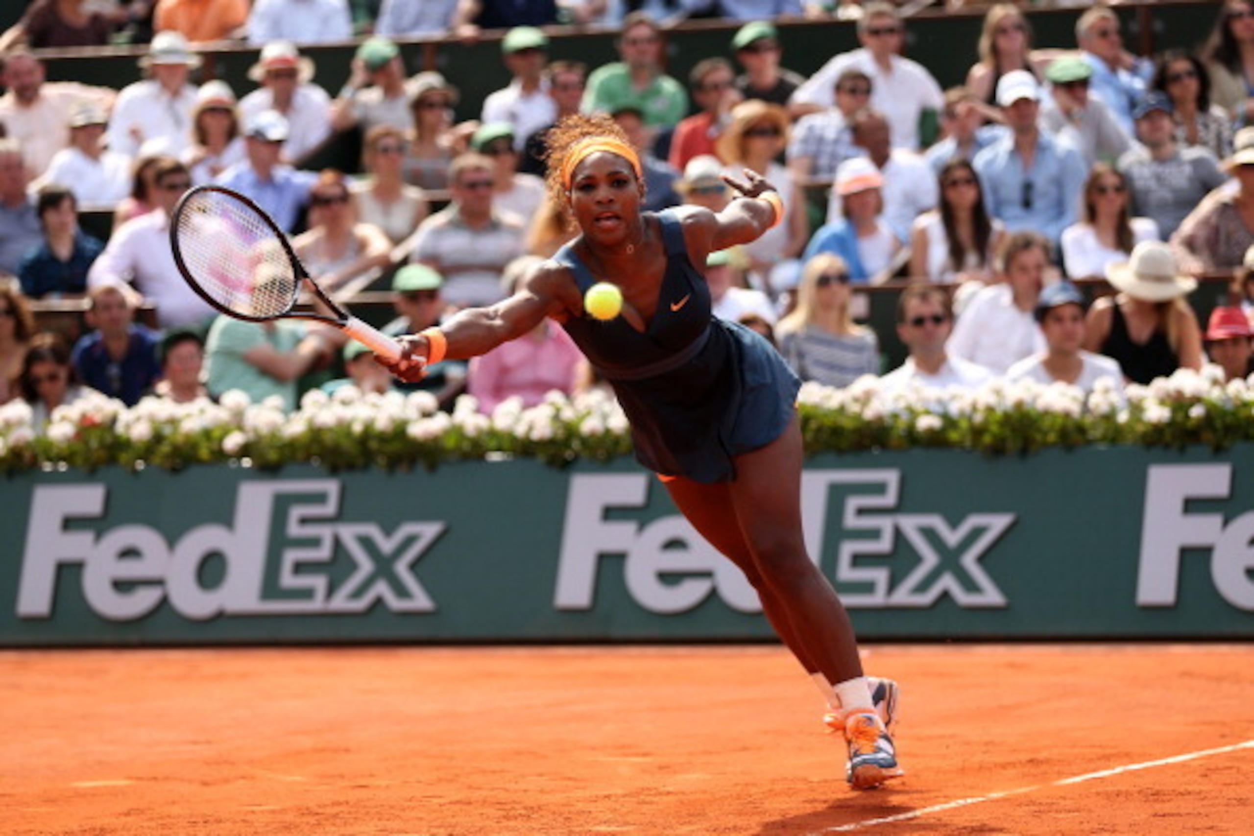 Serena Williams reaches to make a play on the ball at the 2013 French Open final.