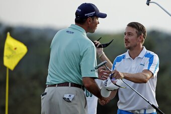 Matt Kuchar and Jonas Blixt end their rounds with a handshake.