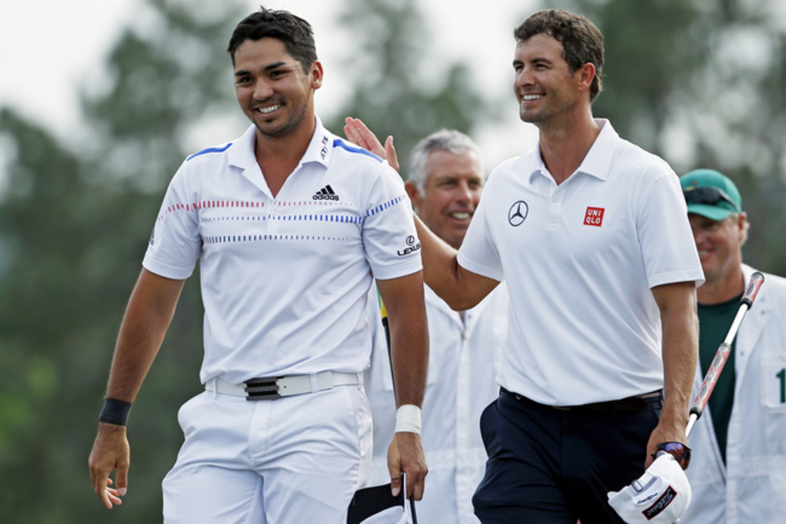 Australians Jason Day and Adam Scott walk off the 18th green Sunday.