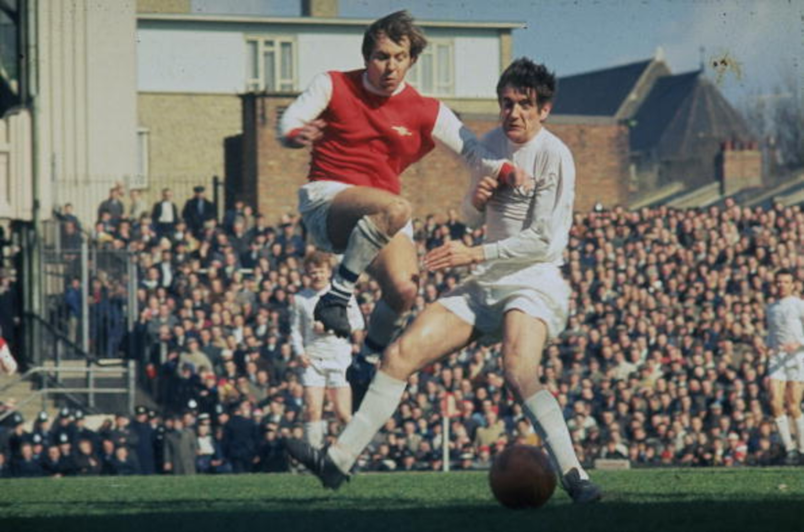 Norman Hunter, in white, makes a tackle