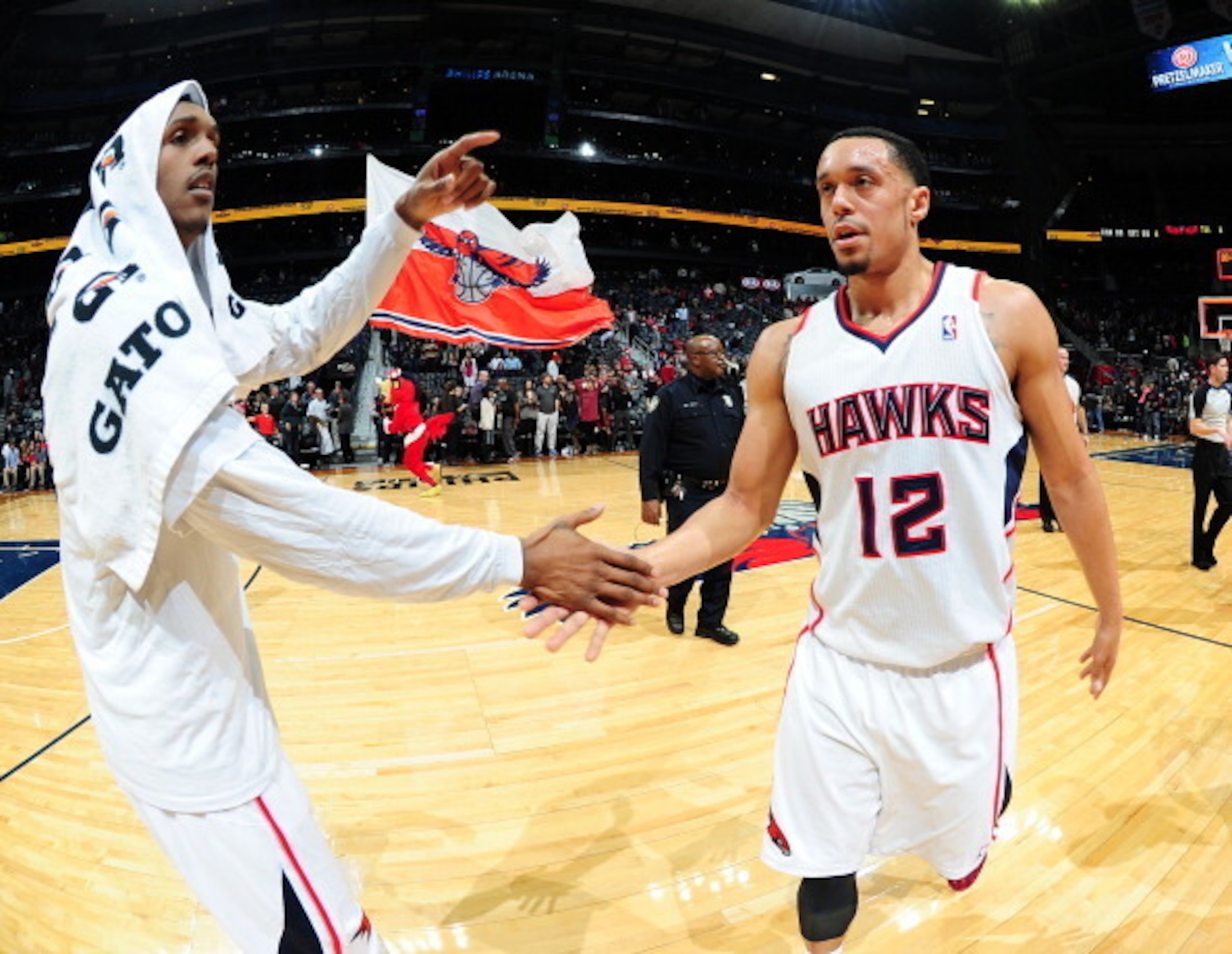 John Jenkins (right) slaps hands with teammate Louis Williams.