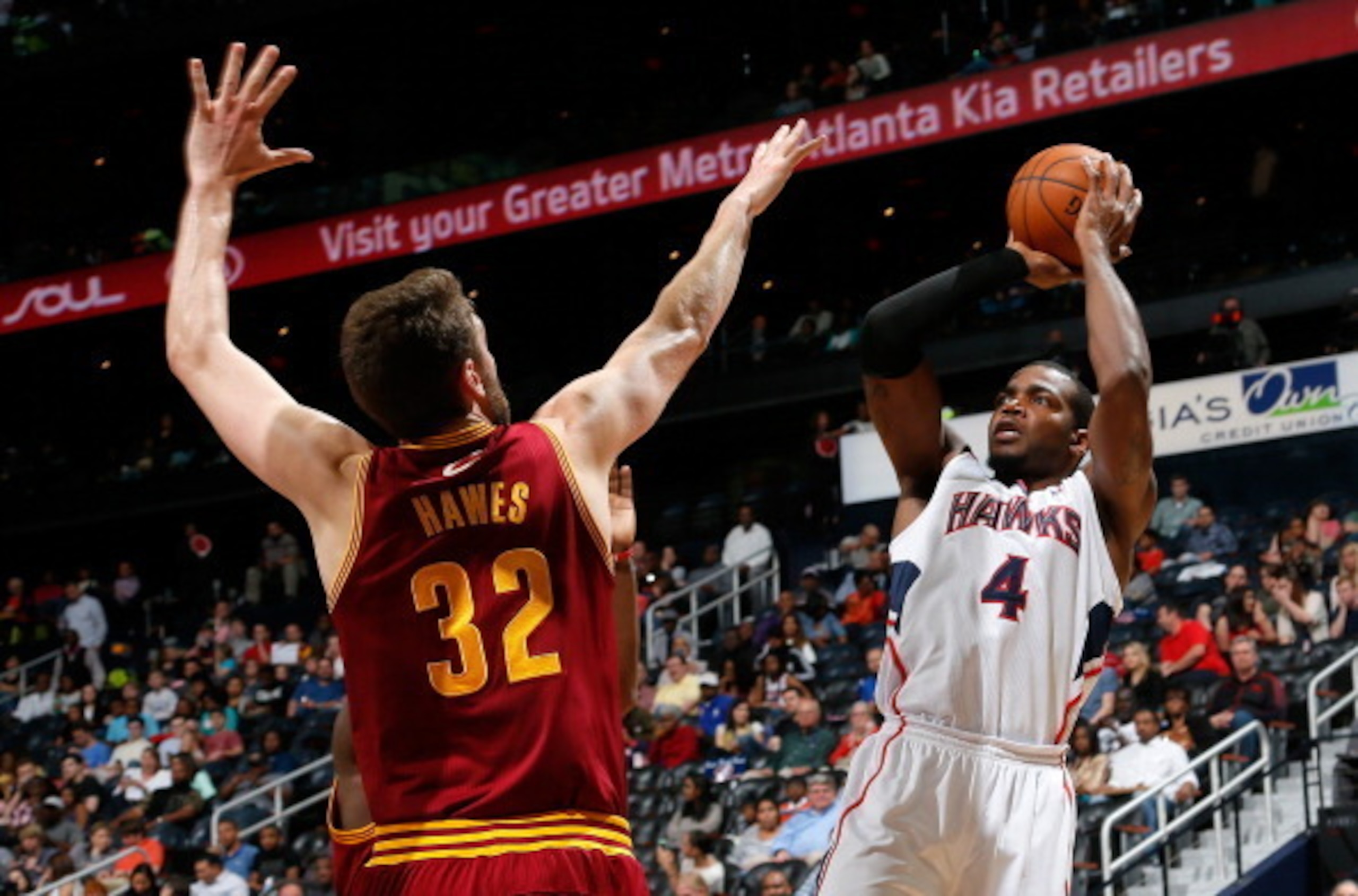 Paul Millsap shoots over Cleveland Cavaliers center Spencer Hawes.