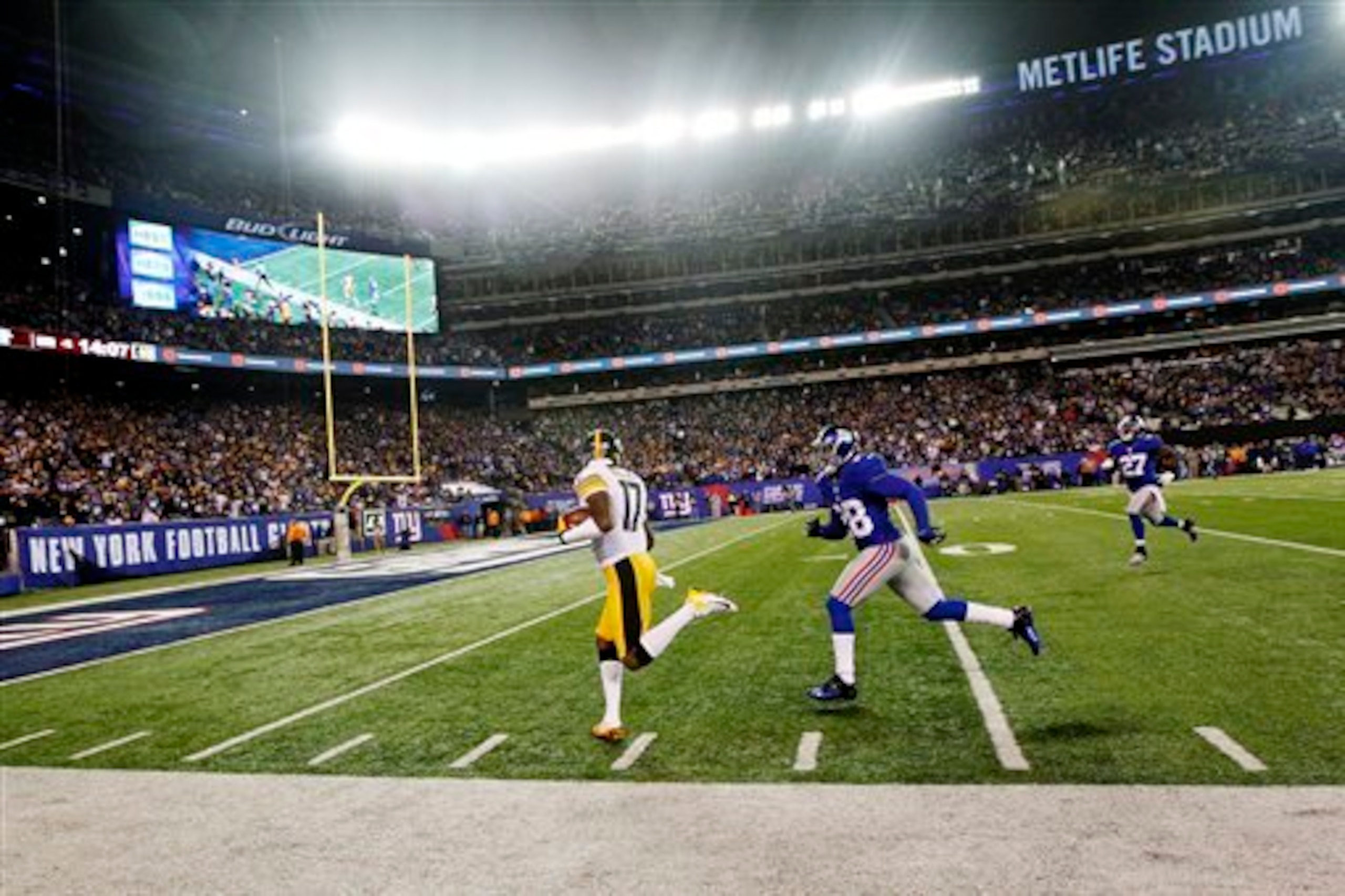 Then-rookie Jayron Hosley chases then-Steelers WR Mike Wallace in 2012.