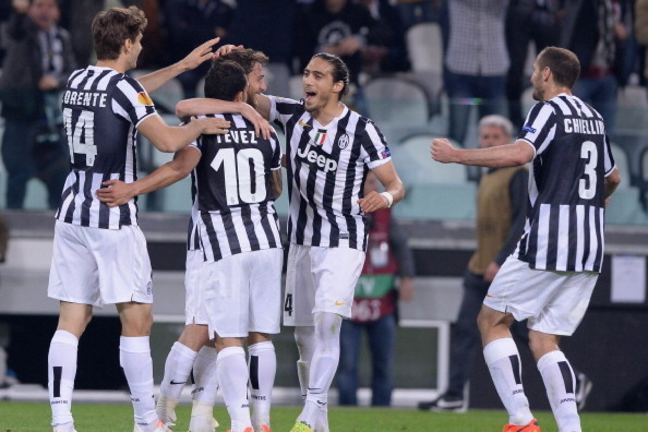 Juventus players surround Claudio Marchisio after his decisive strike in the Europa League quarterfinal against Lyon.