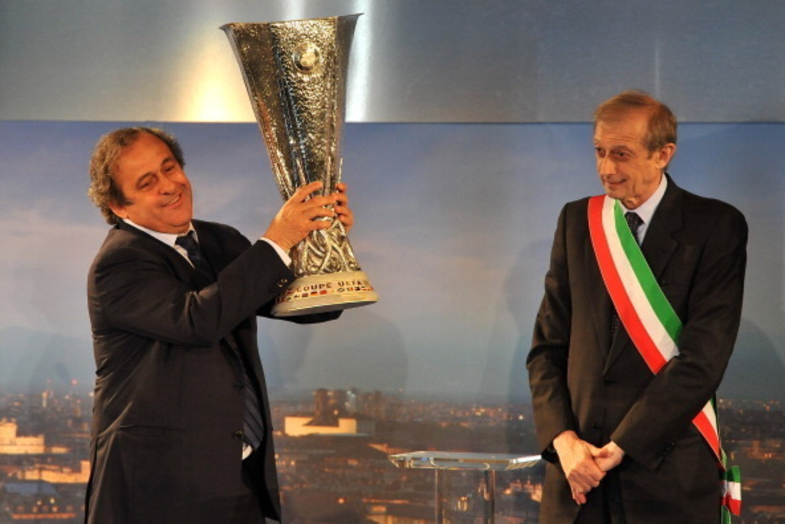 Michel Platini plays his part in the Europa League trophy handover ceremony in Turin.