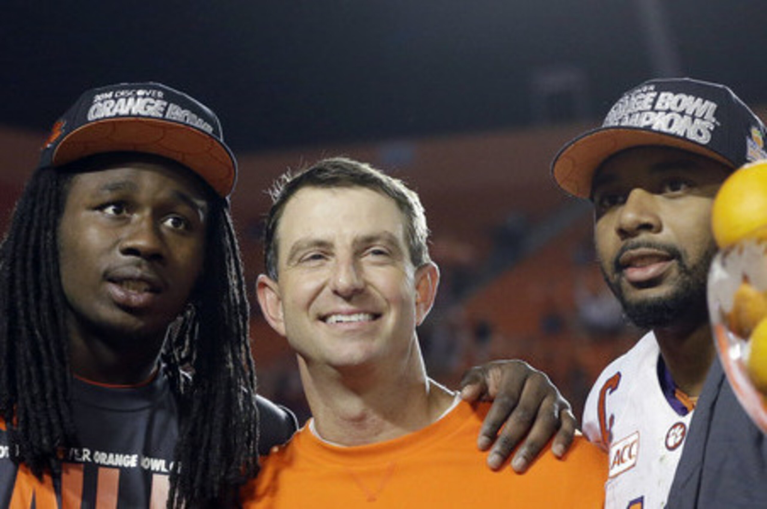 Clemson head coach Dabo Swinney surrounded by former stars Sammy Watkins (left) and Tajh Boyd (right).