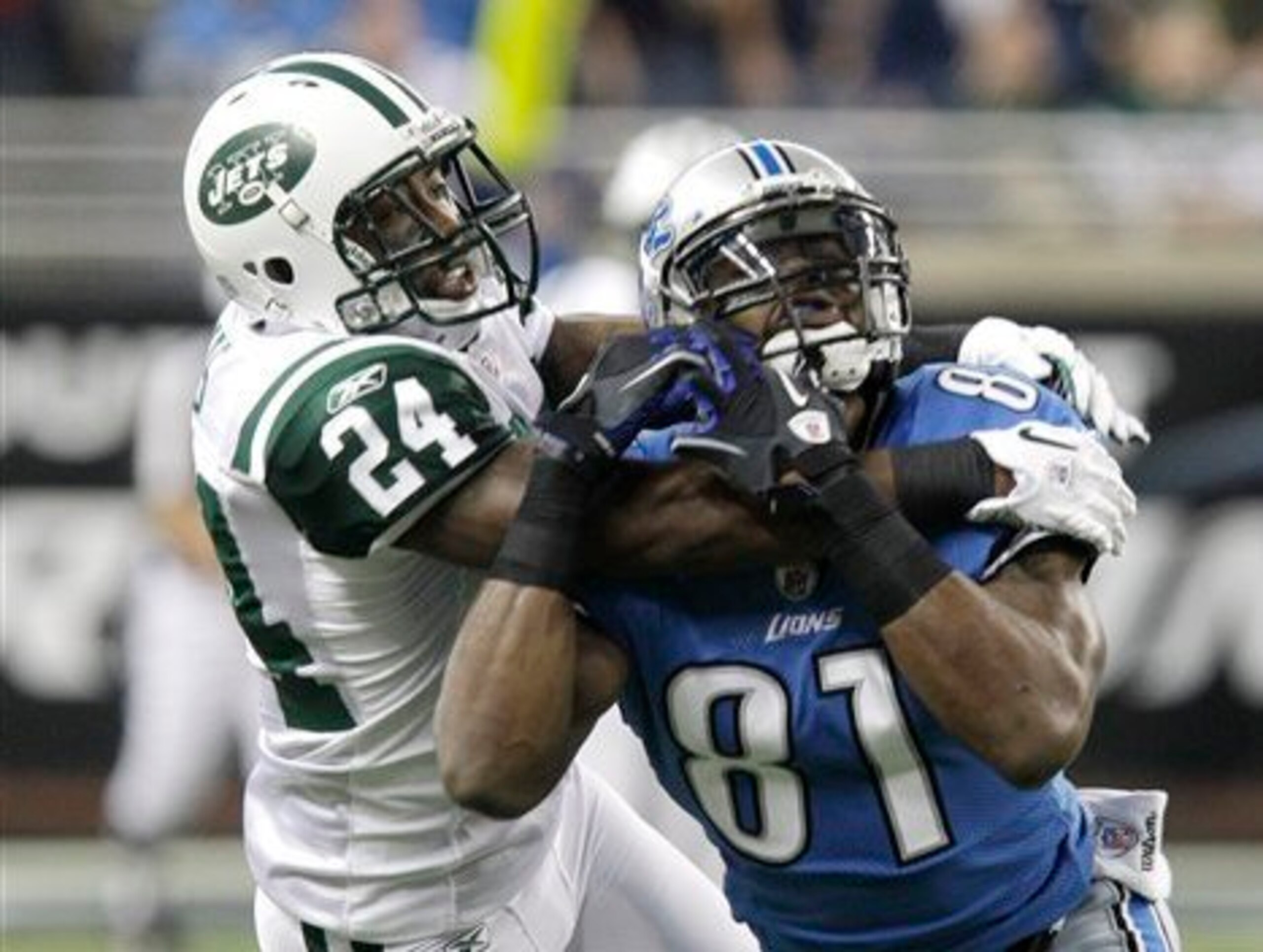 New York Jets cornerback Darrelle Revis (24) breaks up a pass intended for Detroit Lions wide receiver Calvin Johnson (81) during the first quarter of an NFL football game at Ford Field in Detroit, Sunday, Nov. 7, 2010. (AP Photo/Carlos Osorio)