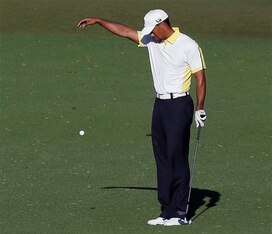 Tiger Woods drops after his previous shot hit the flagstick and bounced into the water on the 15th hole in the second round at the 2013 Masters.