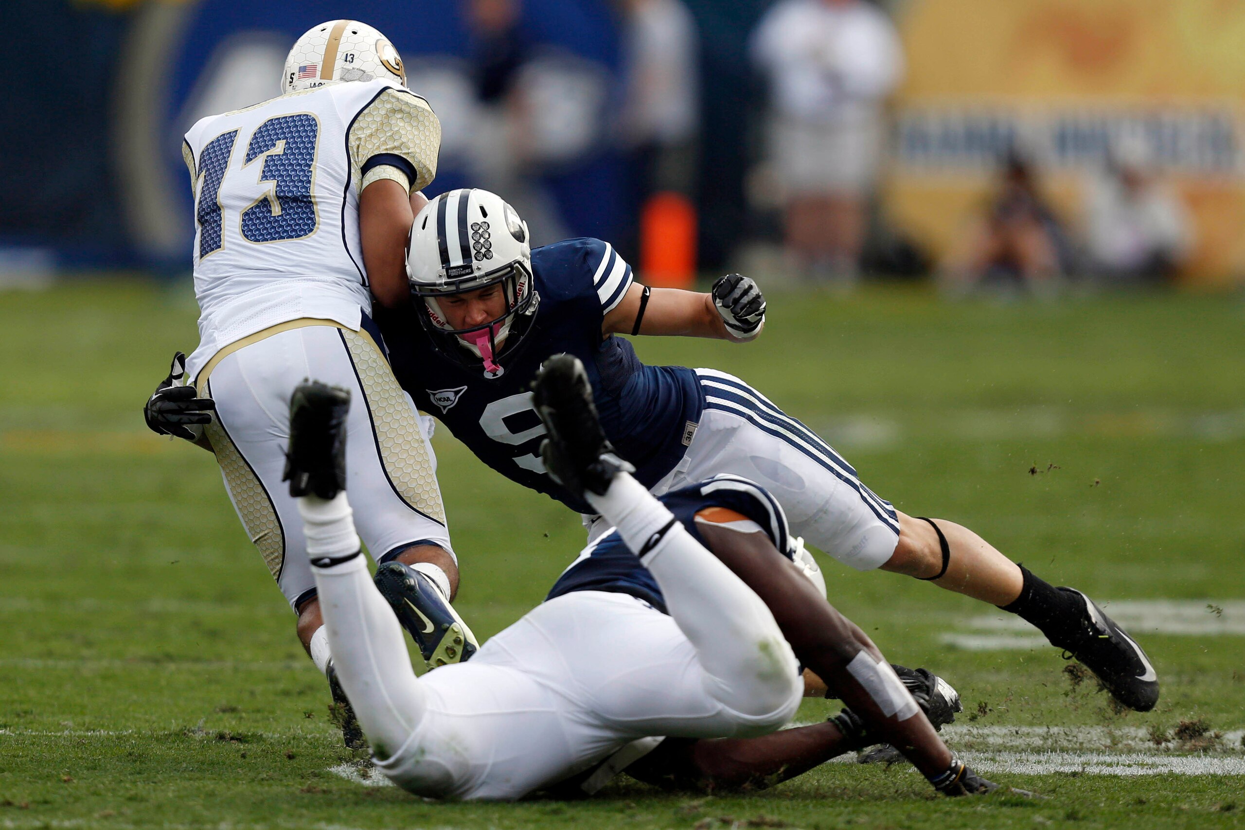 BYU S Daniel Sorensen (9, above) is a willing tackler and a smart football player.