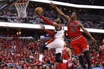 The lightning-fast John Wall slides by the Bulls' Jimmy Butler.