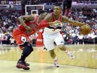 Bradley Beal drives past the Bulls' Jimmy Butler.