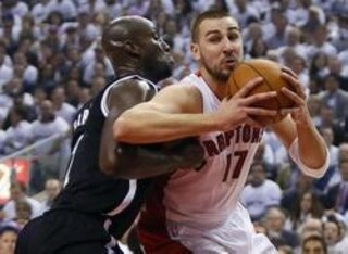 Neophyte Jonas Valanciunas tries to out-muscle veteran Kevin Garnett.