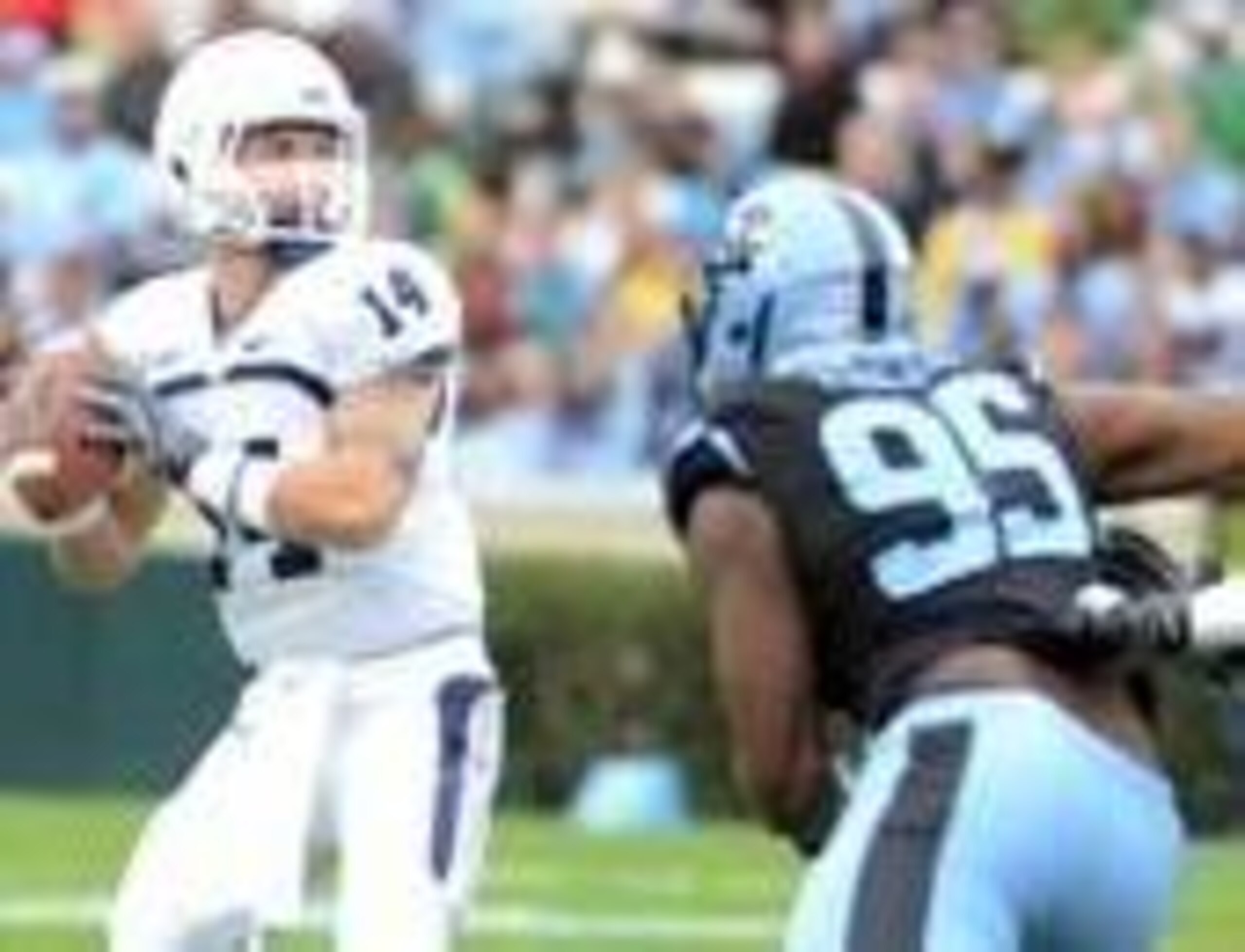 Nov 23, 2013; Chapel Hill, NC, USA; Old Dominion Monarchs quarterback Taylor Heinicke (14) drops back to pass as North Carolina Tar Heels defensive end Kareem Martin (95) pressures during the first half at Kenan Memorial Stadium. Mandatory Credit: Rob Kin