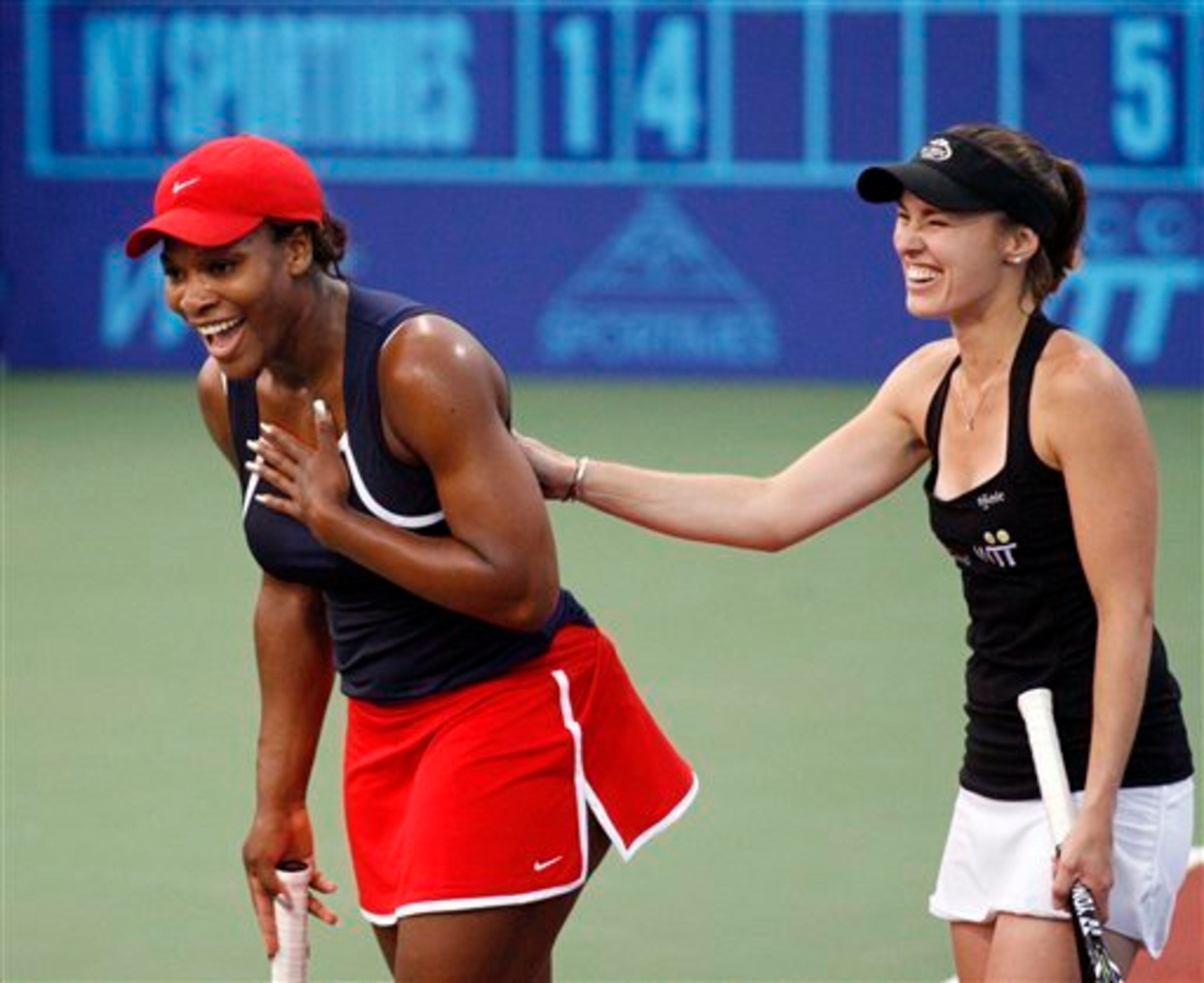 Serena Williams and Martina Hingis enjoying exhibition during World Team Tennis event in 2011.