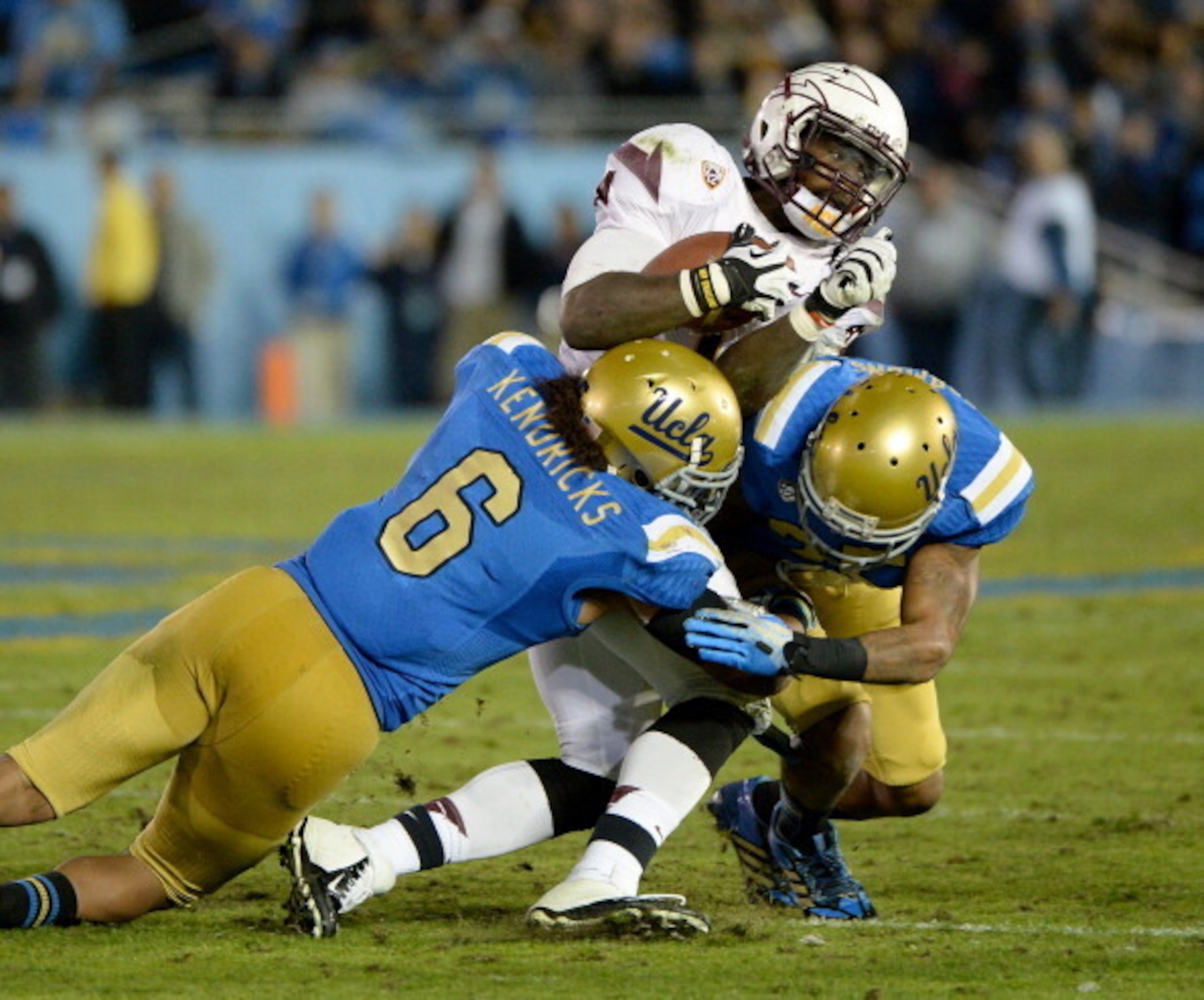 PASADENA, CA - NOVEMBER 23:  Marion Grice #1 of the Arizona State Sun Devils is hit by Eric Kendricks #6 of the UCLA Bruins and Brandon Sermons #25 for a stop on third down during the third quarter at Rose Bowl on November 23, 2013 in Pasadena, California