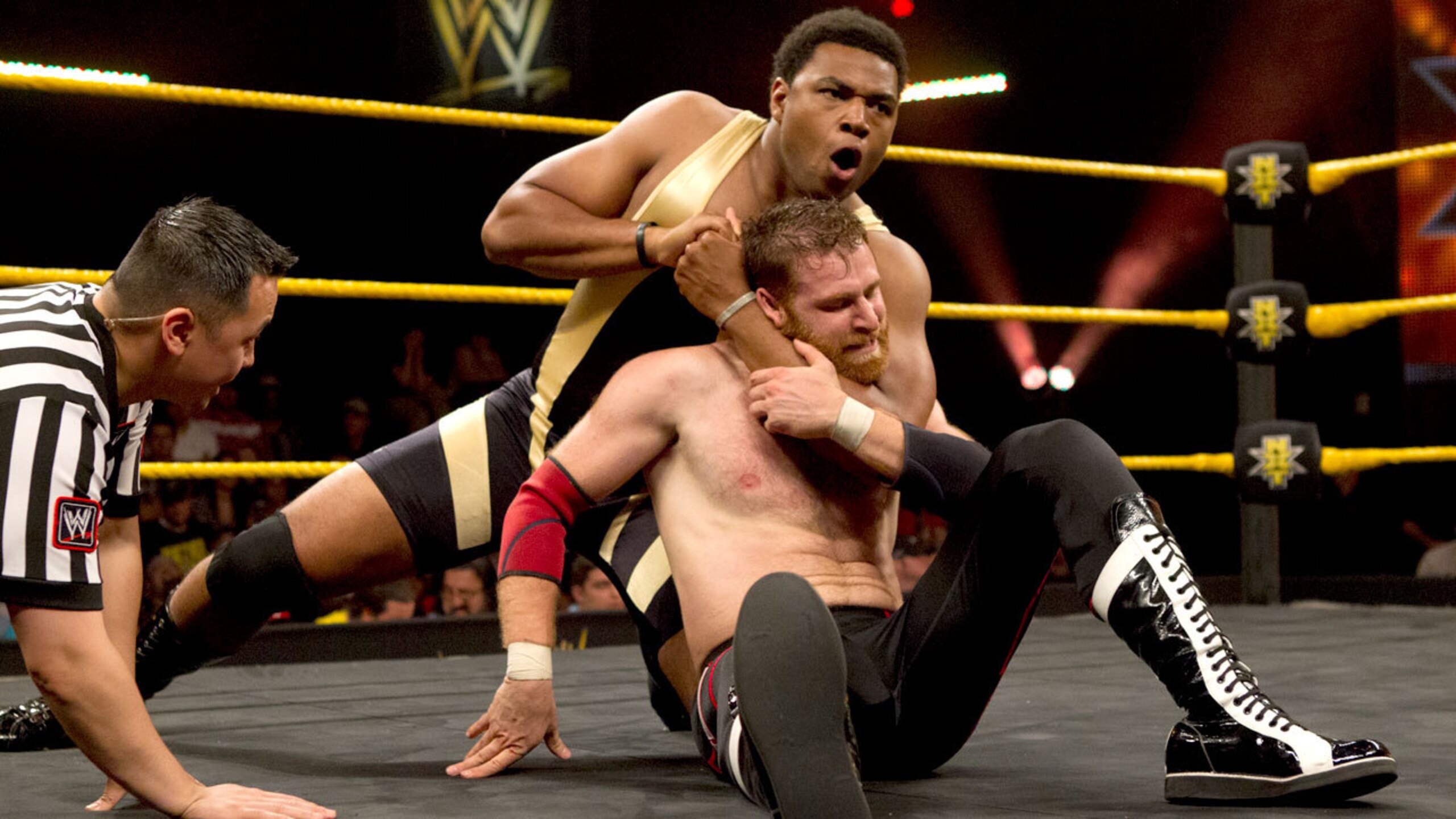 Angelo Dawkins battles Sami Zayn.
