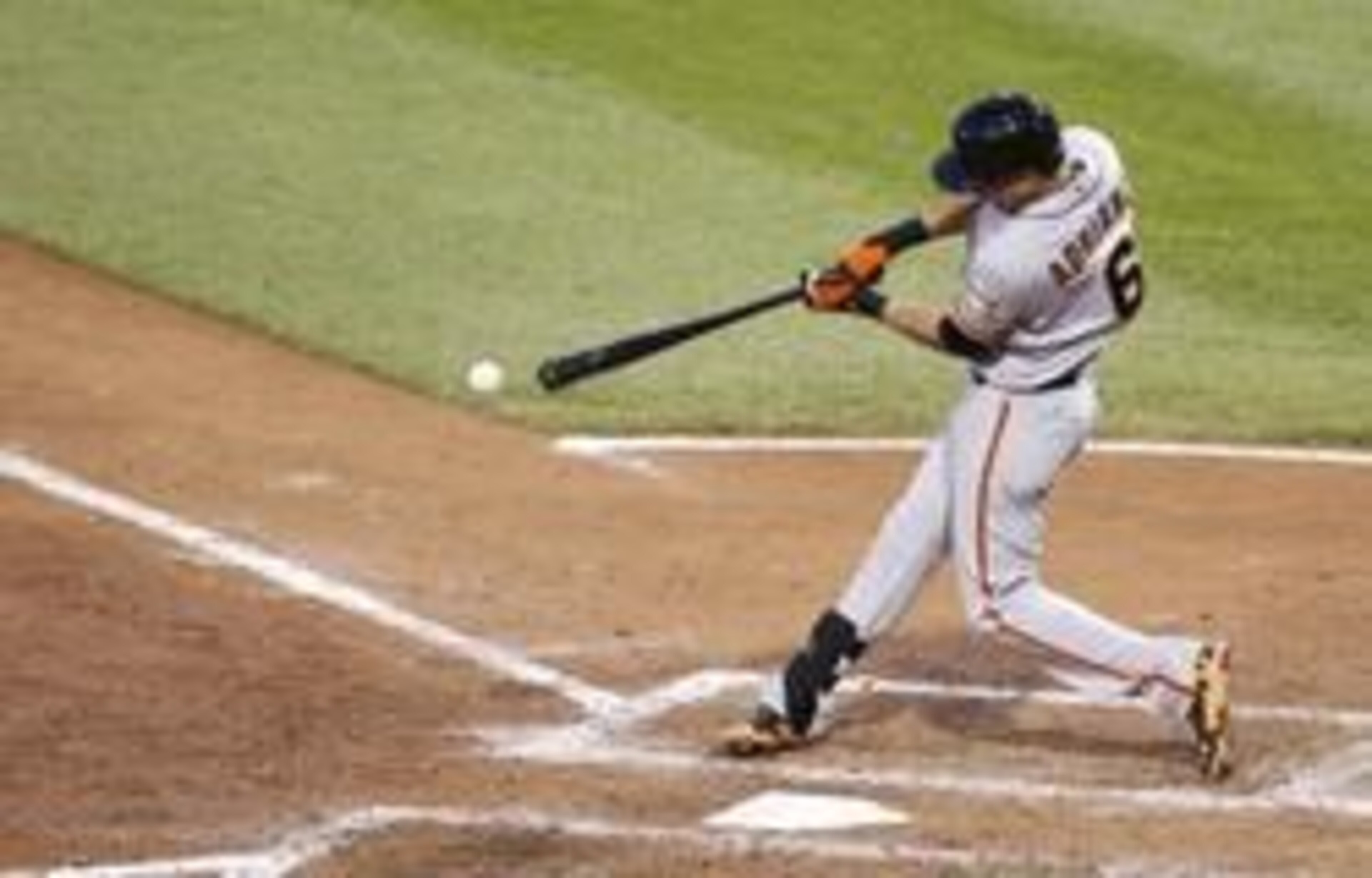 May 6, 2014; Pittsburgh, PA, USA; San Francisco Giants second baseman Ehire Adrianza (6) singles against the Pittsburgh Pirates during the fifth inning at PNC Park. The Pirates won 2-1. Mandatory Credit: Charles LeClaire-USA TODAY Sports