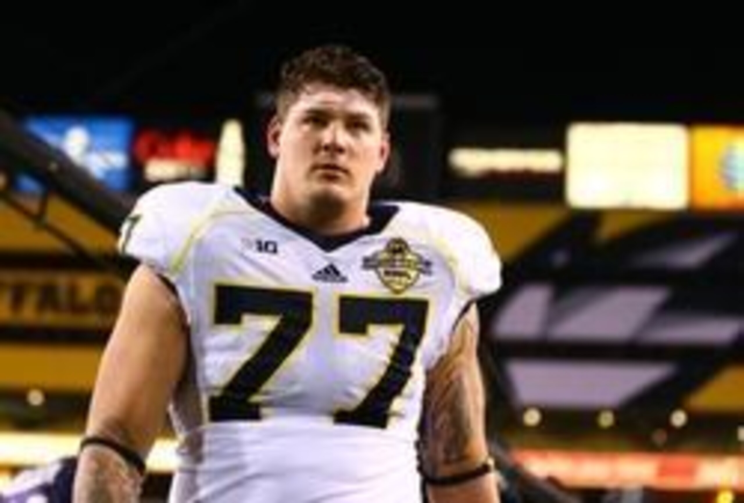 Dec 28, 2013; Tempe, AZ, USA; Michigan Wolverines offensive lineman Taylor Lewan (77) walks off the field following the game against the Kansas State Wildcats during the Buffalo Wild Wings Bowl at Sun Devil Stadium. Kansas State defeated Michigan 31-14. M