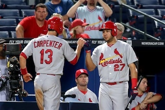 Matt Carpenter celebrates with Jhonny Peralta after scoring a run in a game against the Braves on May 8.