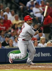 Yadier Molina gets a hit against the Braves on May 6.
