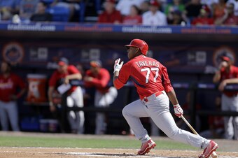 Oscar Taveras gets a hit in a Spring Training game against the Mets on March 7.