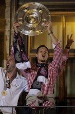 The big Belgian brandishes the Bundesliga trophy