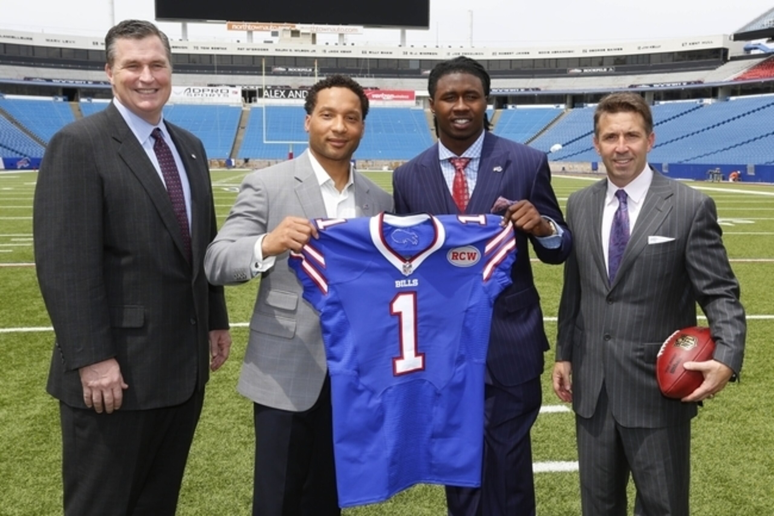 The Buffalo Bills braintrust of head coach Doug Marrone (left), GM Doug Whaley (middle left) and team president Russ Brandon (right) welcome WR Sammy Watkins (middle right).